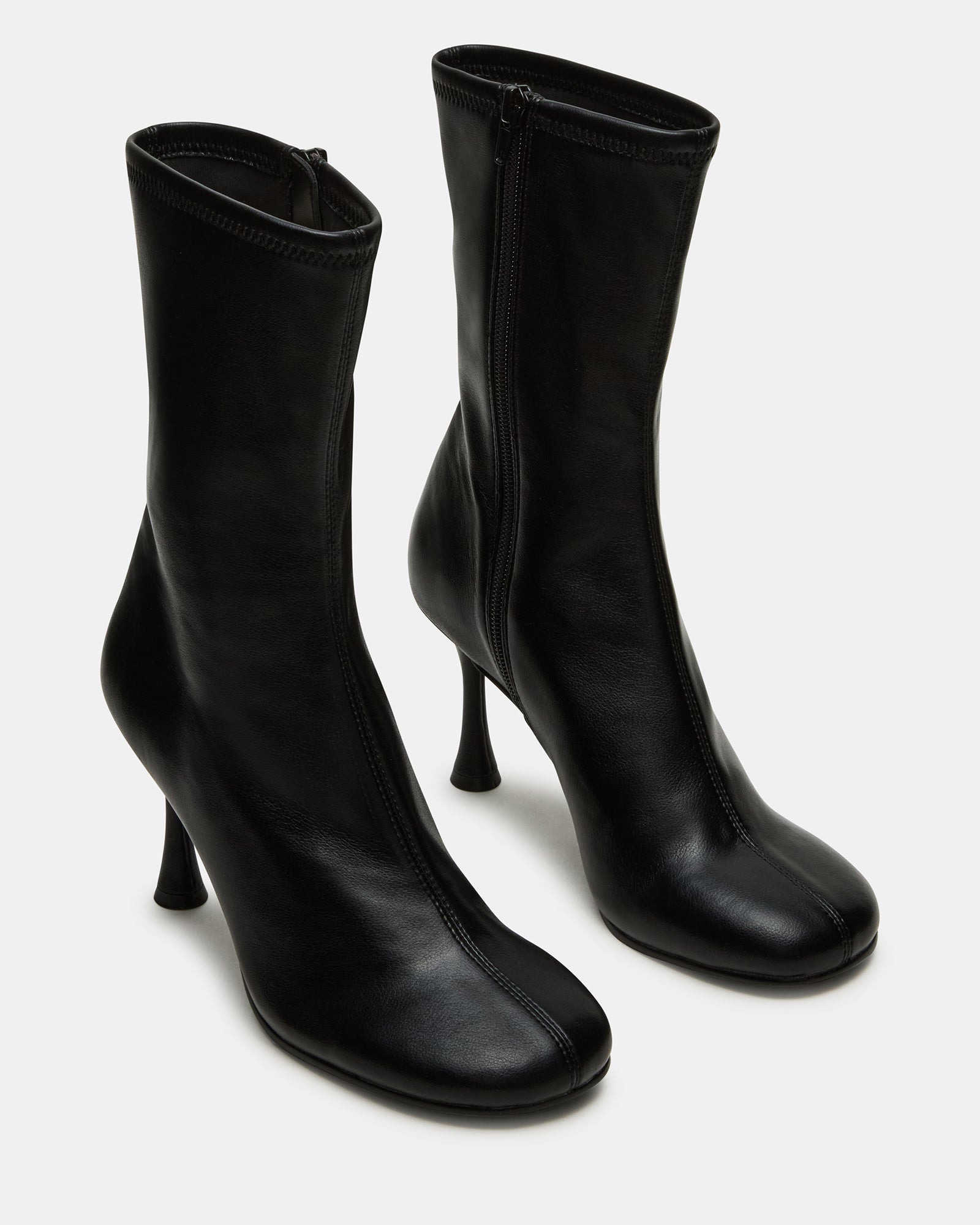 Side view of women’s healed boots styled with slim-fit jeans