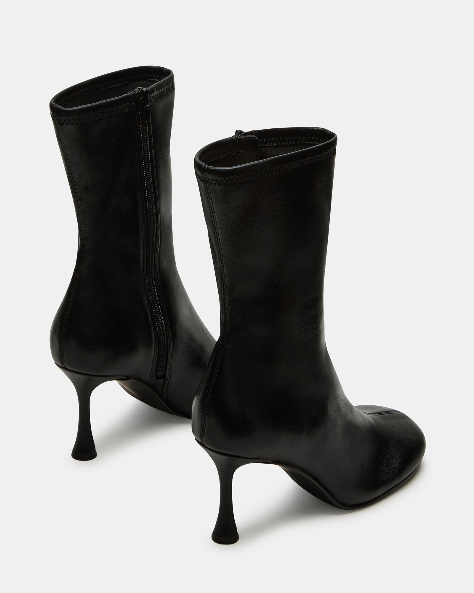 Side view of women’s healed boots styled with slim-fit jeans