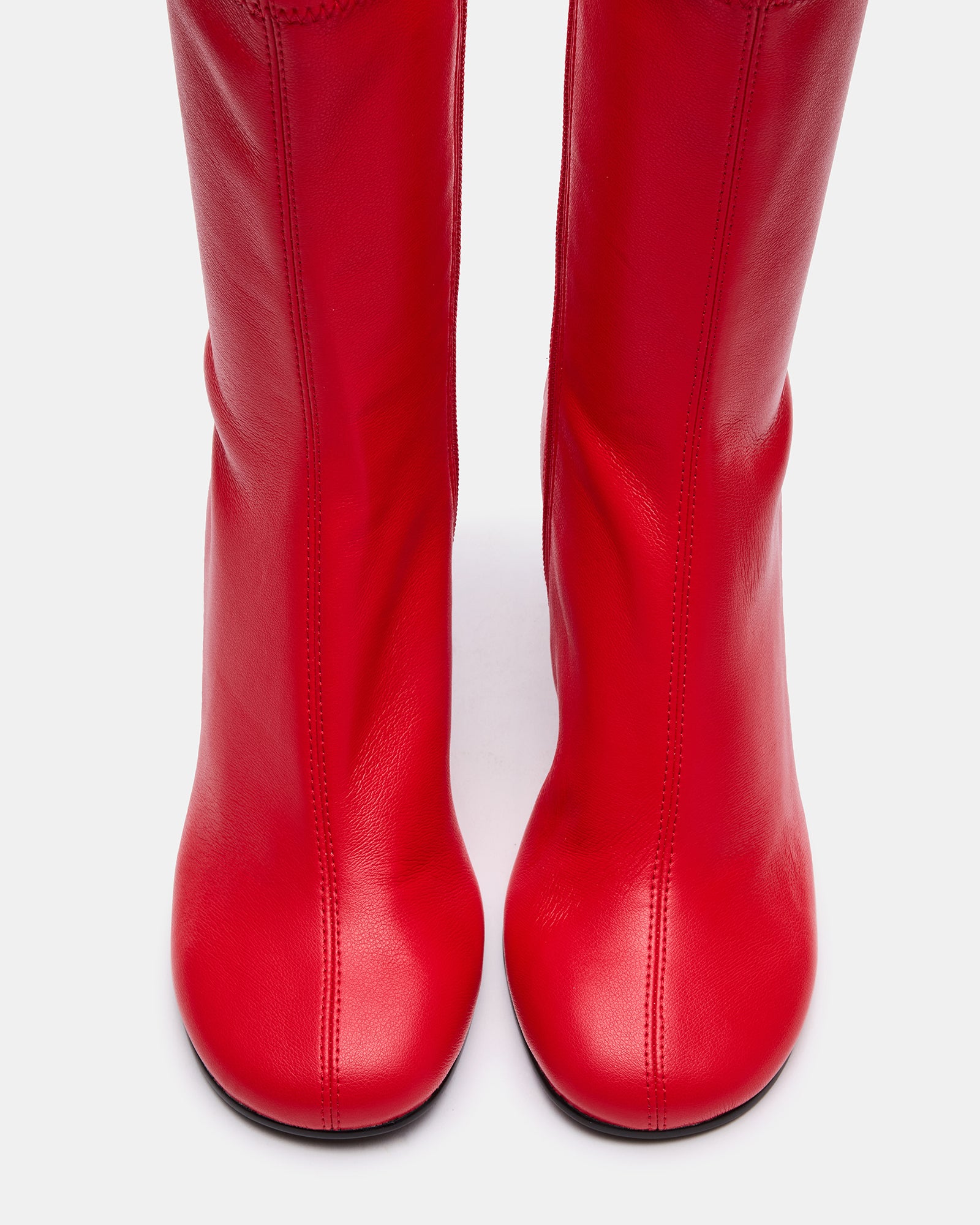 Side view of black booties with heel, showcasing sleek design.