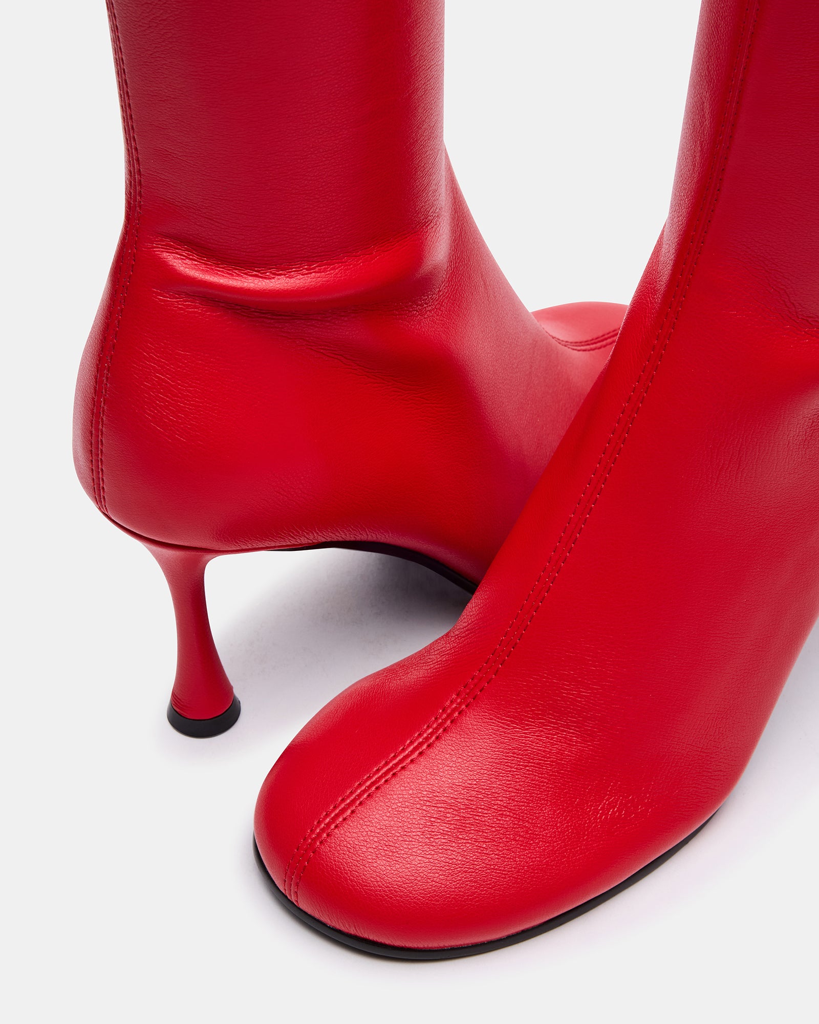 Close-up of vegan leather black booties heel highlighting quality craftsmanship.