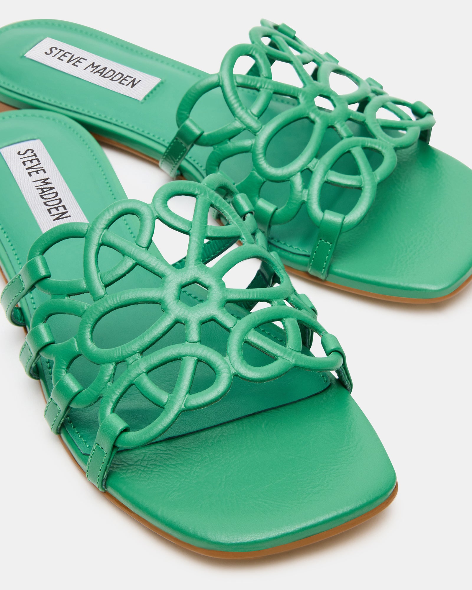 Lifestyle shot of womens minimalist sandals worn with wide-leg trousers