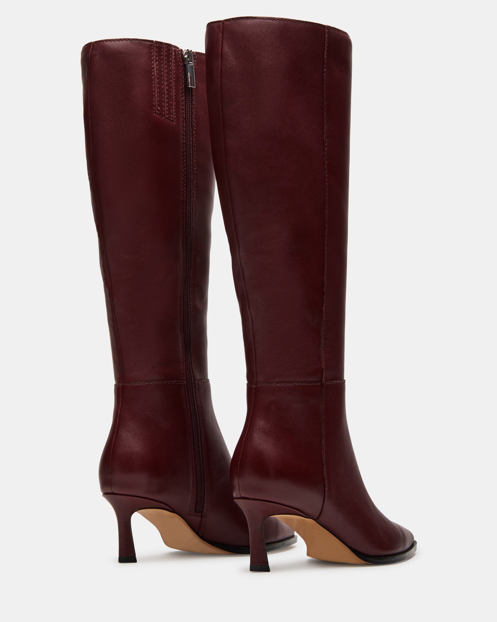 Side view of knee-high boots showcasing leather texture and heel design
