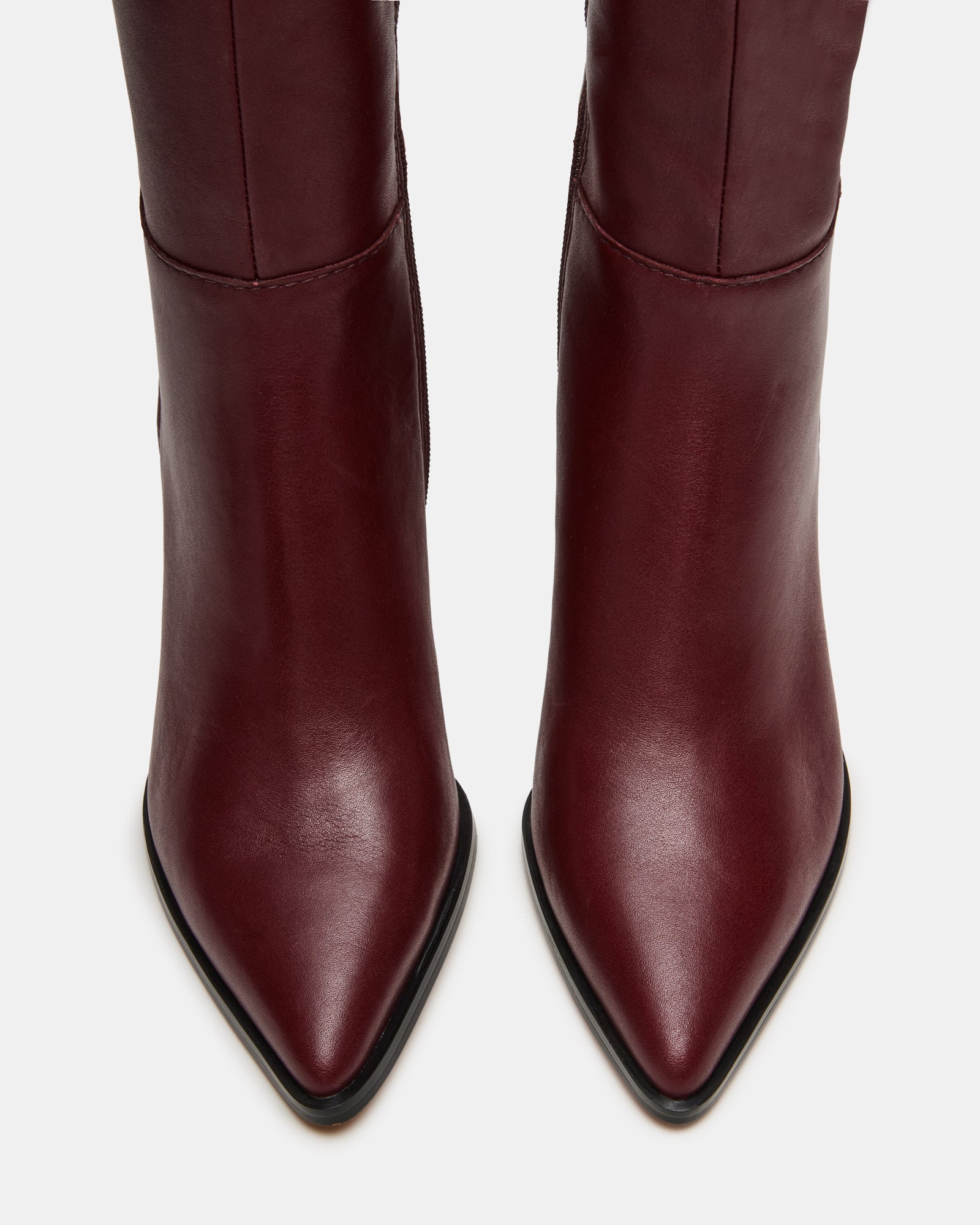 Model wearing Lucid burgundy boots with a stylish autumn outfit