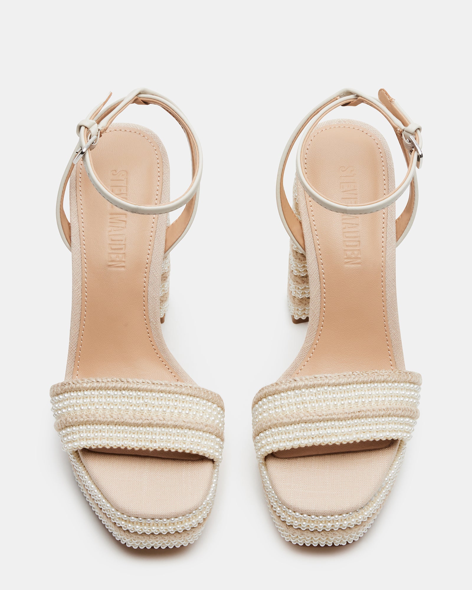 Close-up of raffia platform heels with pearl details for beach weddings