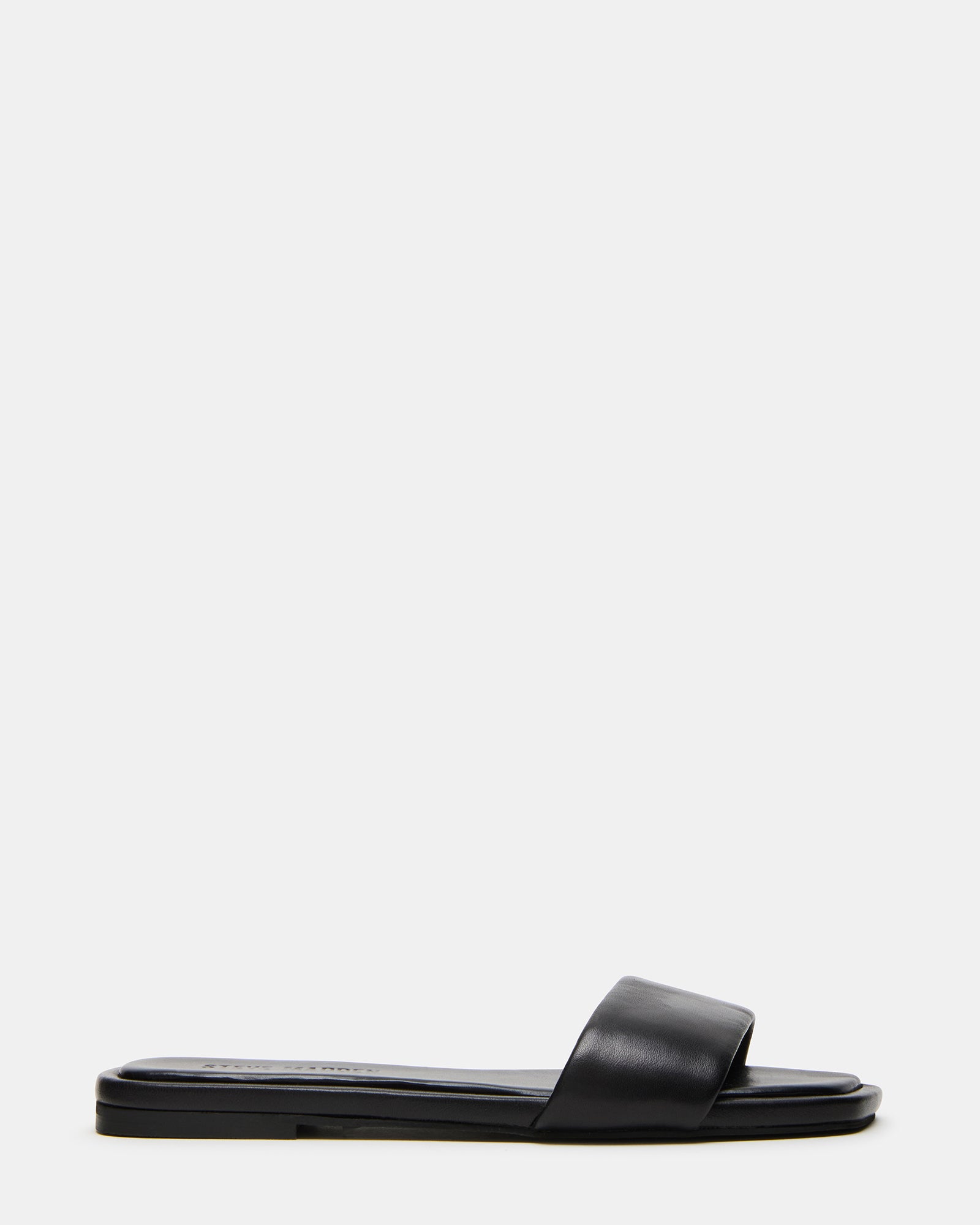 Side view of Lumina black leather sandals on a model’s foot, showcasing the minimalist design