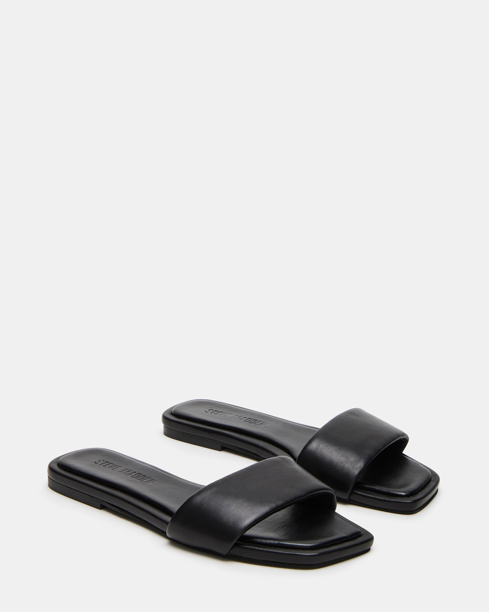 Pair of sandals styled with a summer dress for outfit inspiration