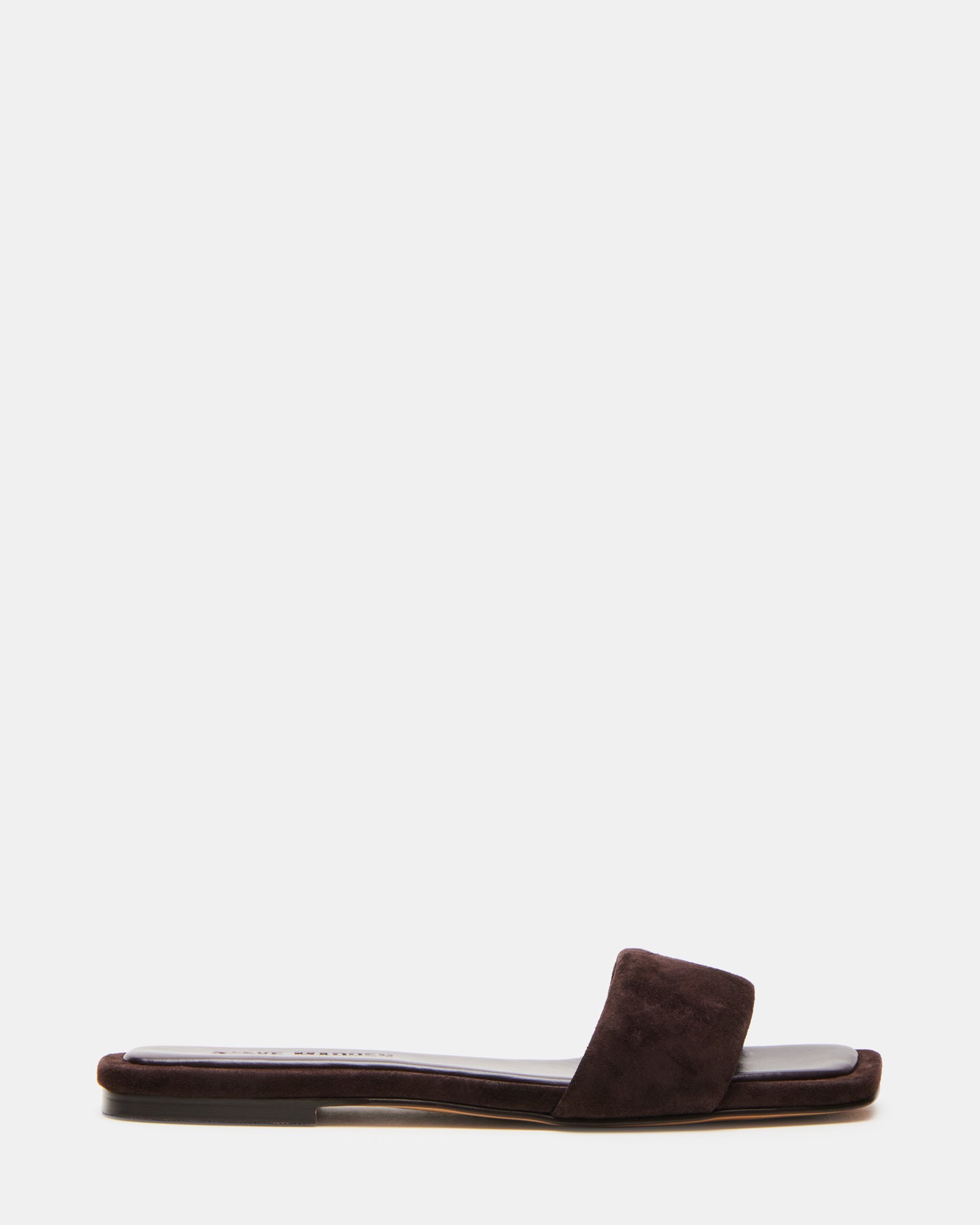 LUMINA suede square toe flat sandals in a stylish outdoor setting.