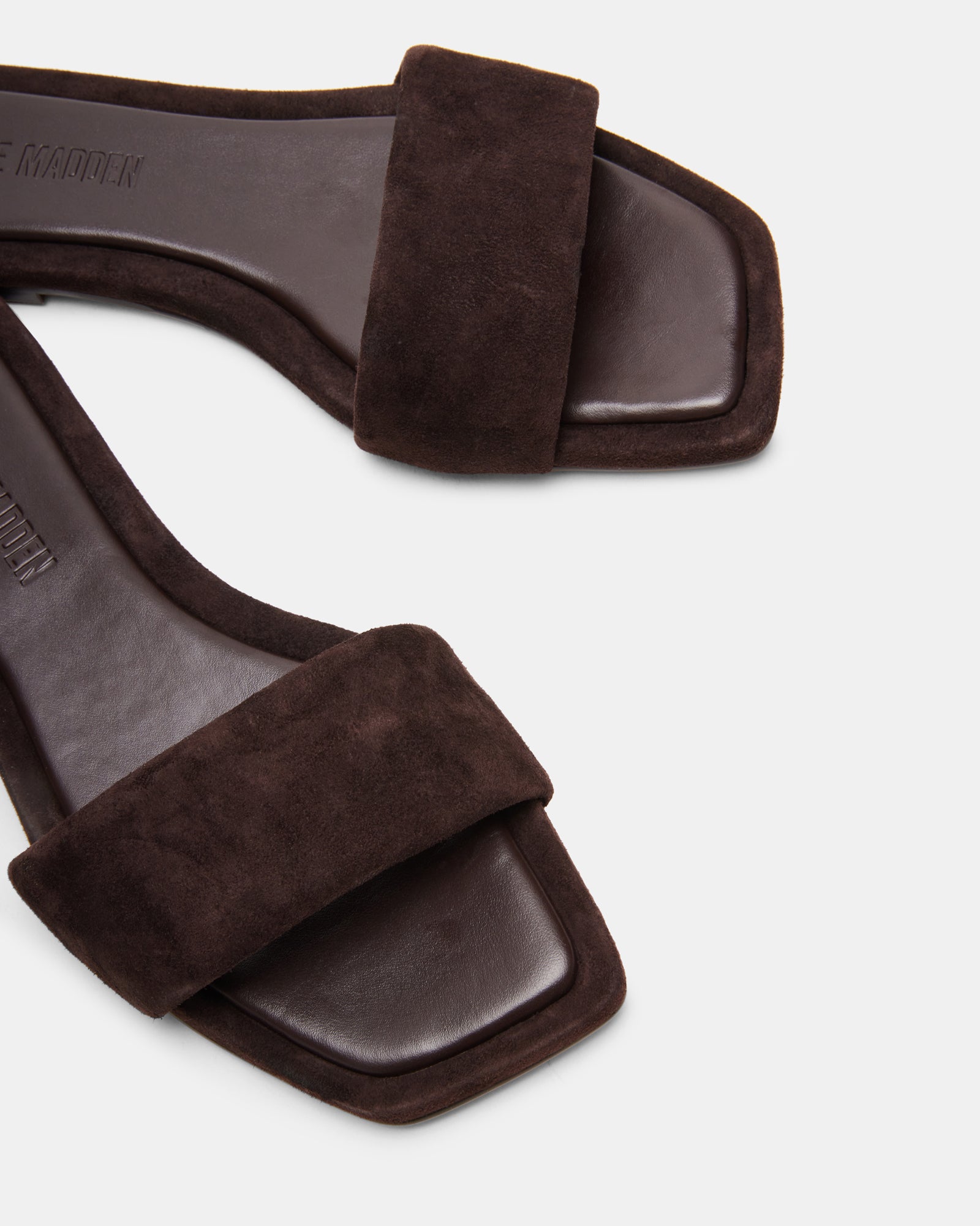LUMINA suede square toe flat sandals in a stylish outdoor setting.