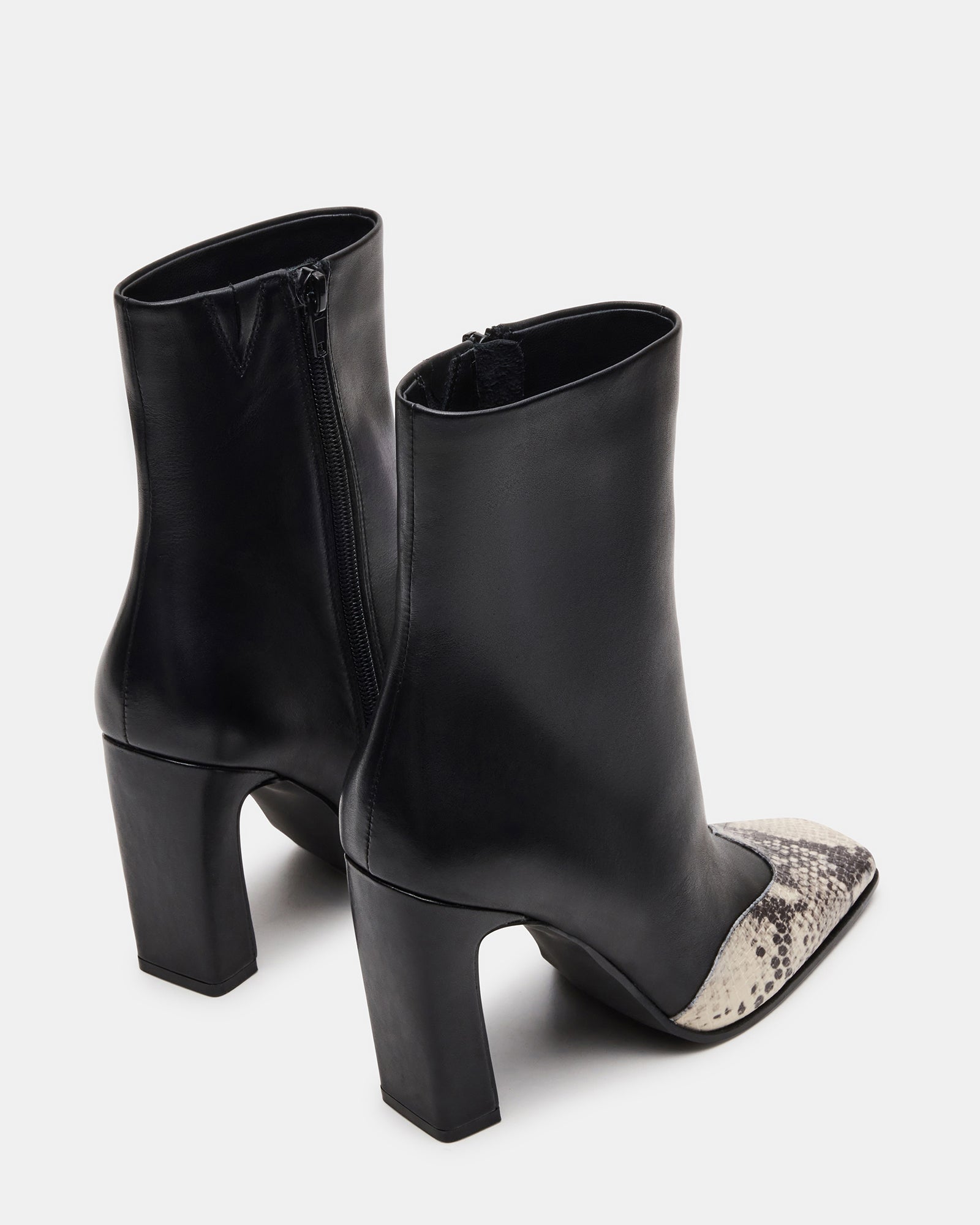 Close-up of snake-print detailing on leather boots.