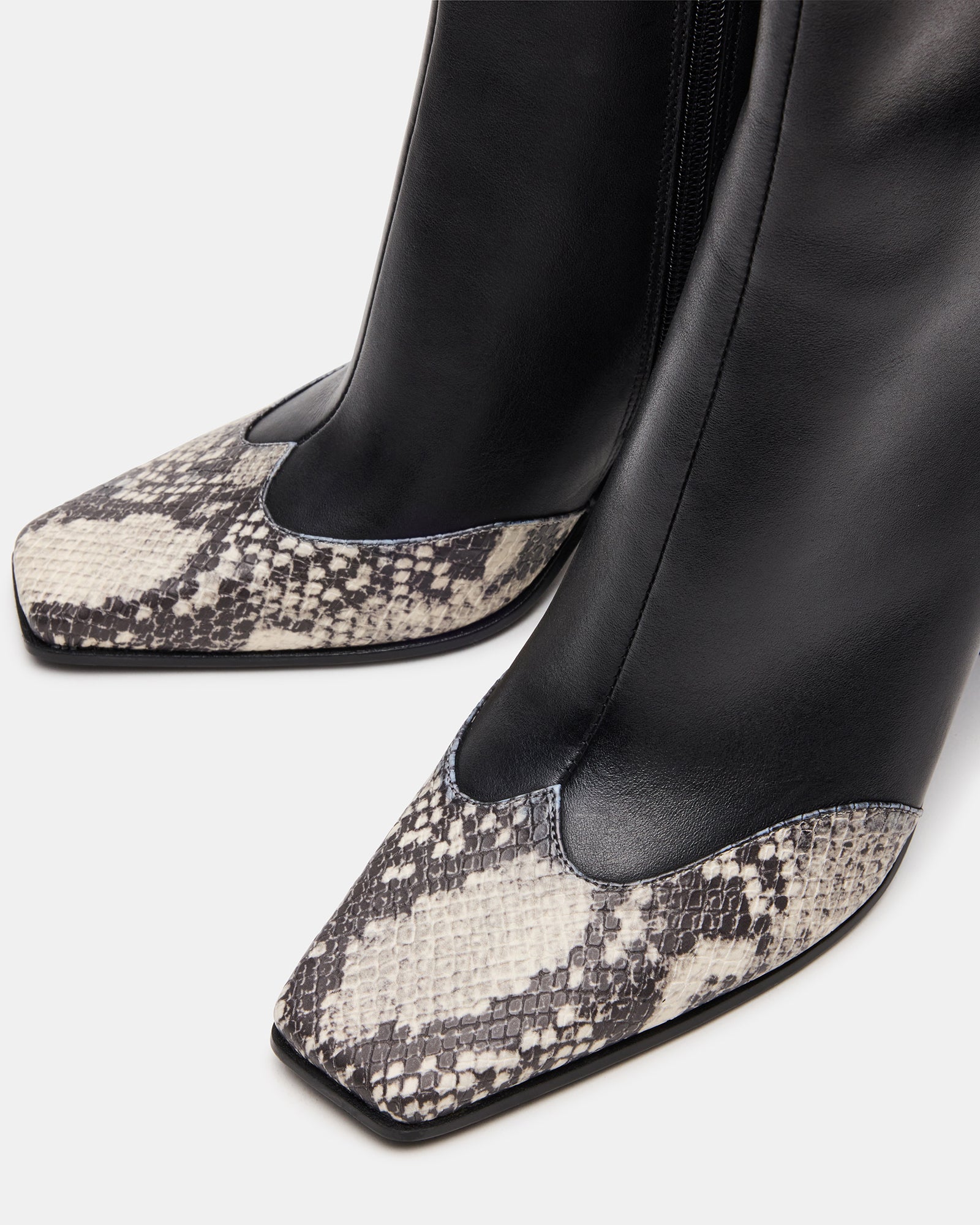 Side profile of heeled booties showing 3.5-inch block heel.
