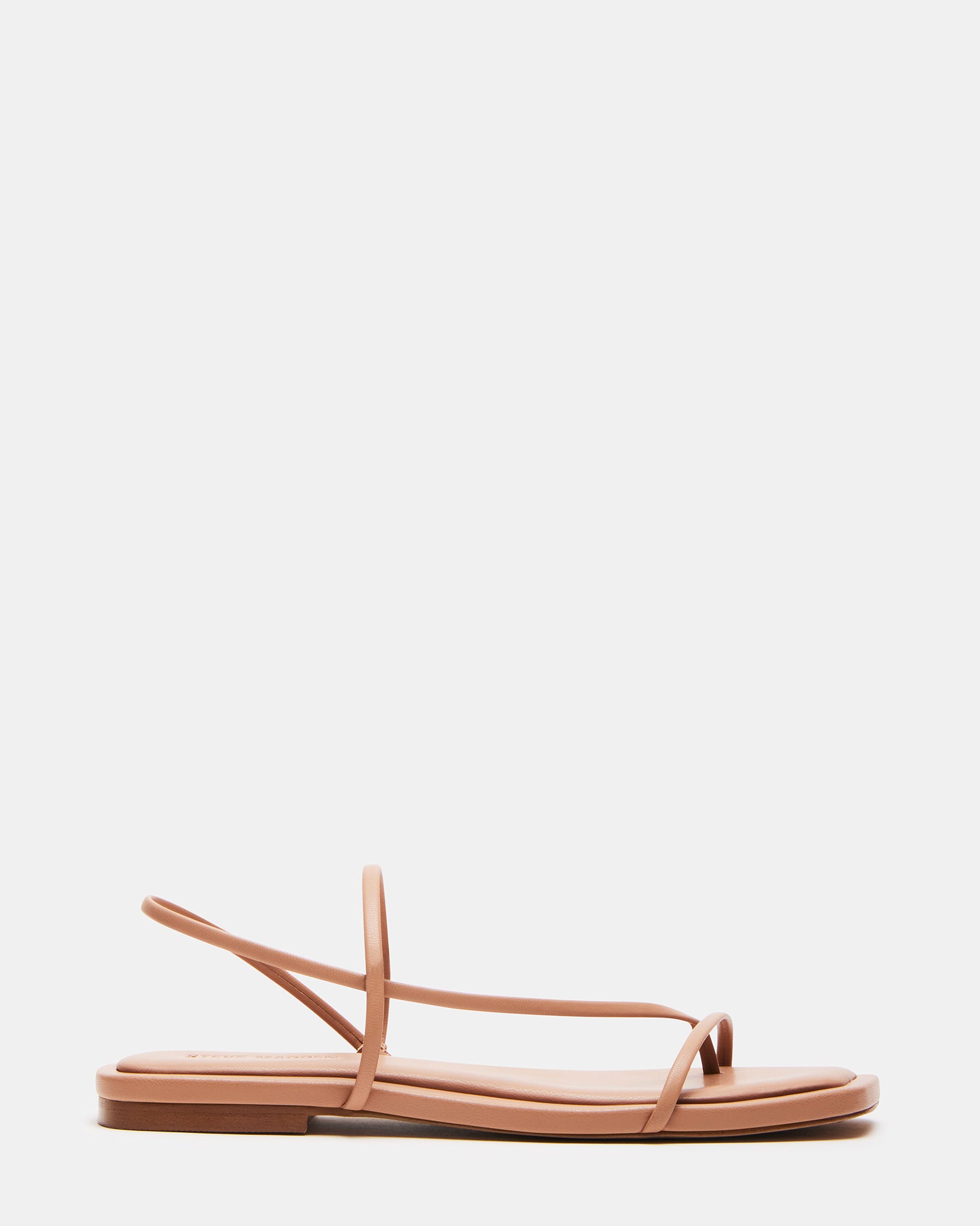 LYNLEY NATURAL vegan wedding shoes displayed on a wooden surface with floral accents