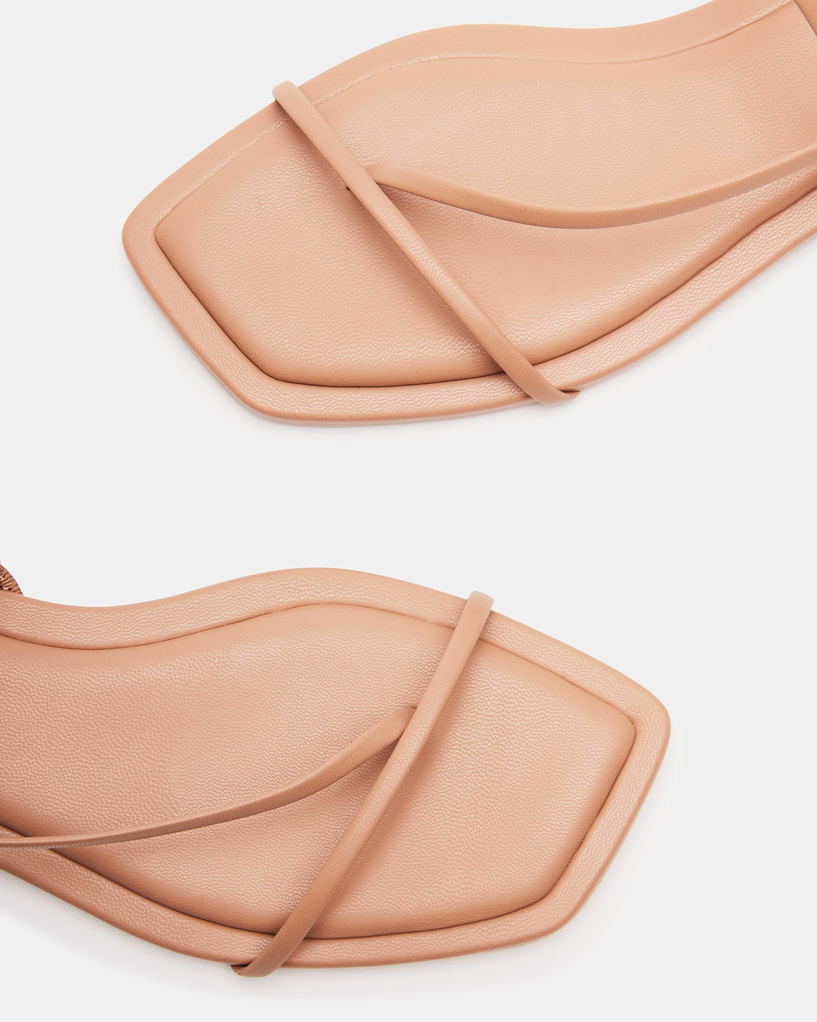 LYNLEY NATURAL vegan wedding shoes displayed on a wooden surface with floral accents