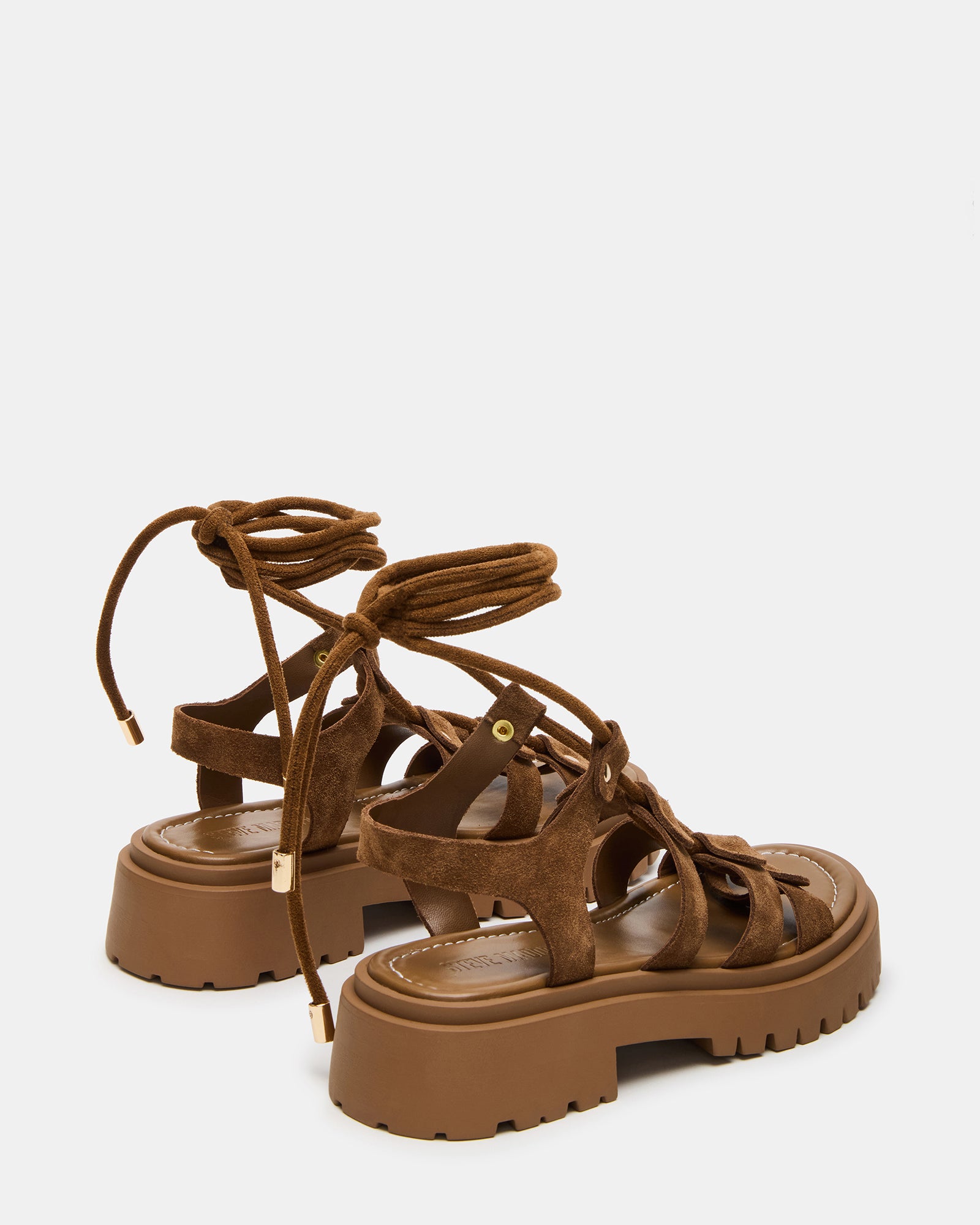 Top-down shot of LYRIAN suede sandals with leg ties for a stylish look