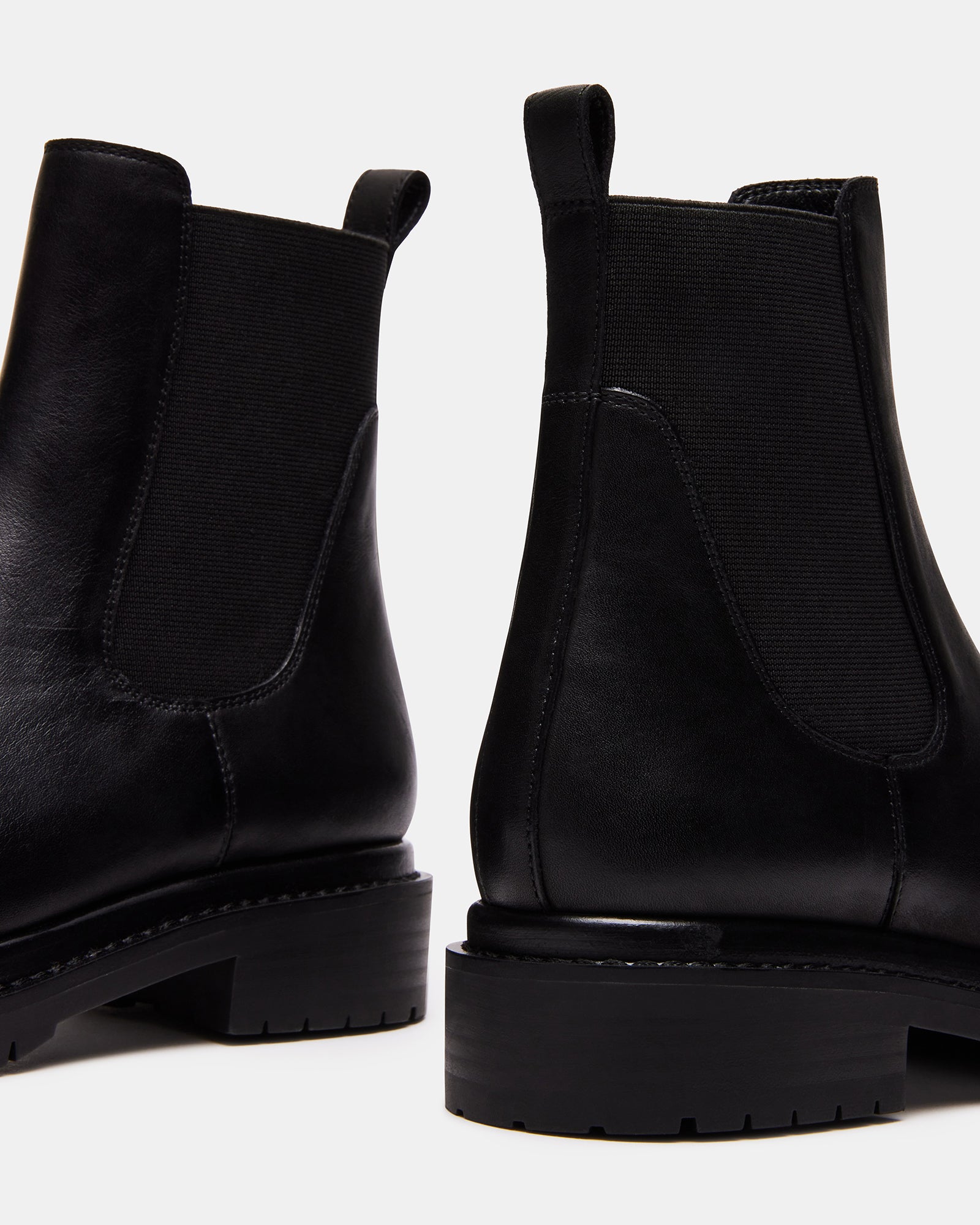 Front view of black leather platform Chelsea boot with textured tread