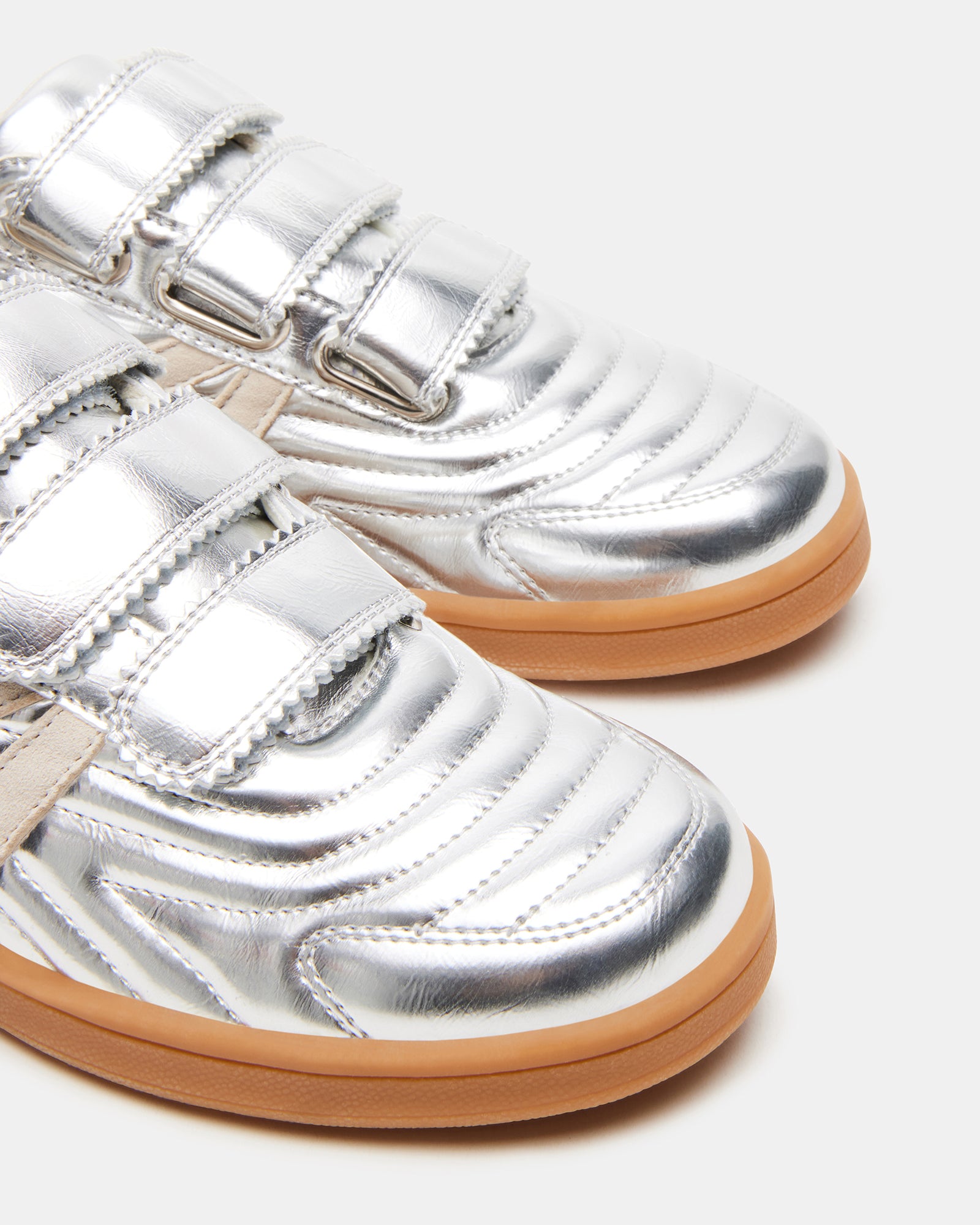 Lifestyle shot of Macer Silver sneakers worn with jeans, perfect for business casual outfits