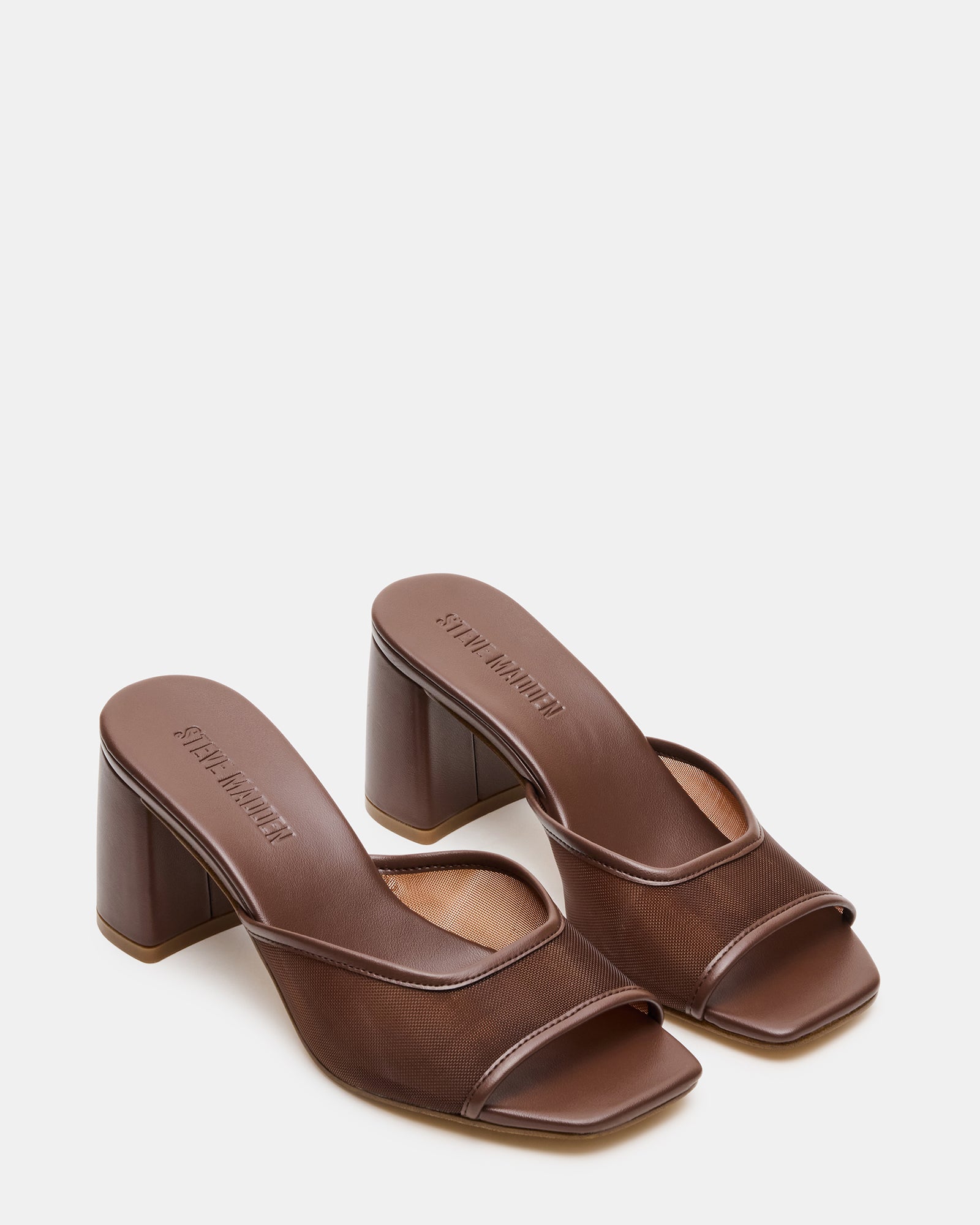 Styled shot of the block heel square toe pumps paired with light trousers outdoors