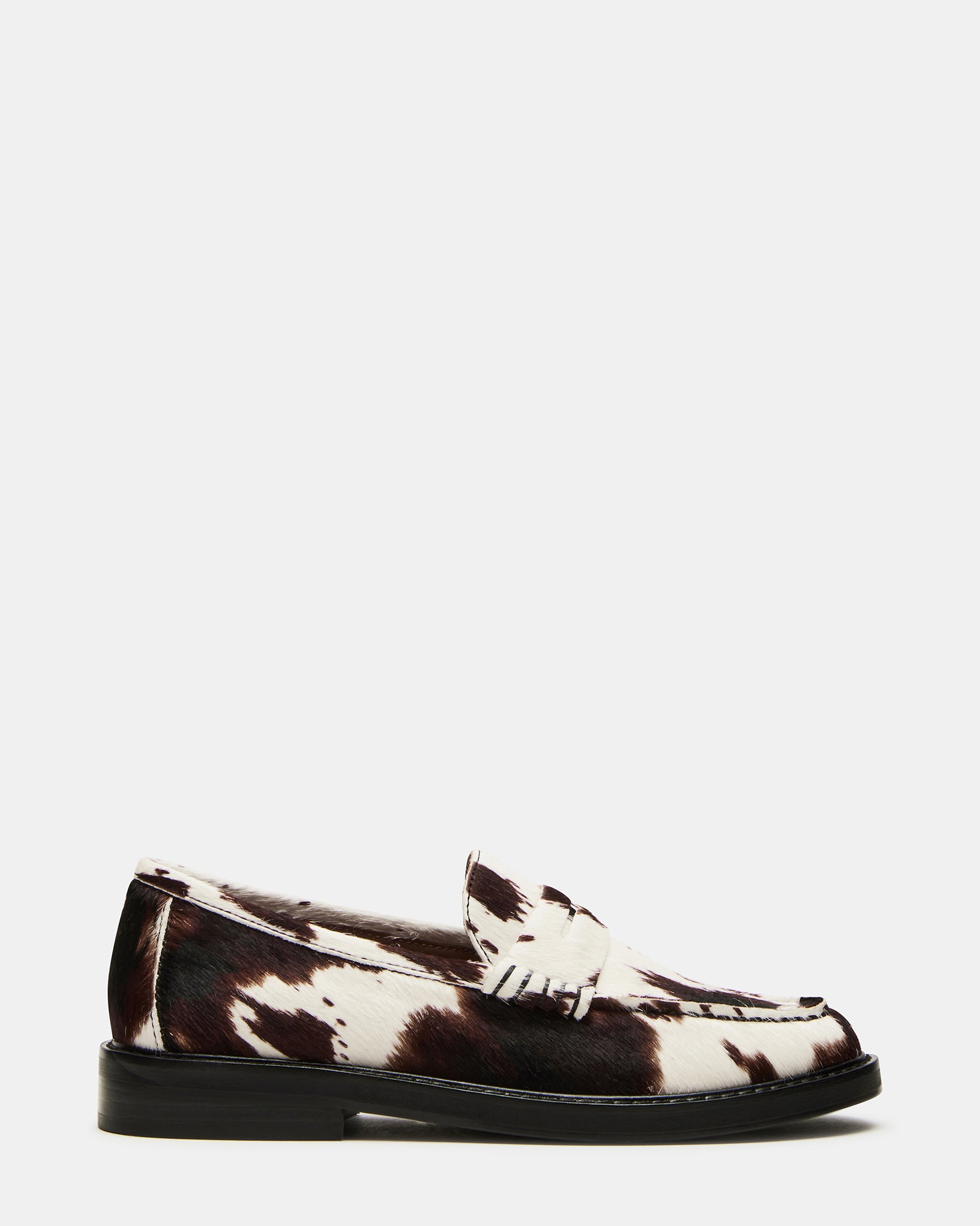 Close-up of Madison cow print loafers highlighting leather texture.
