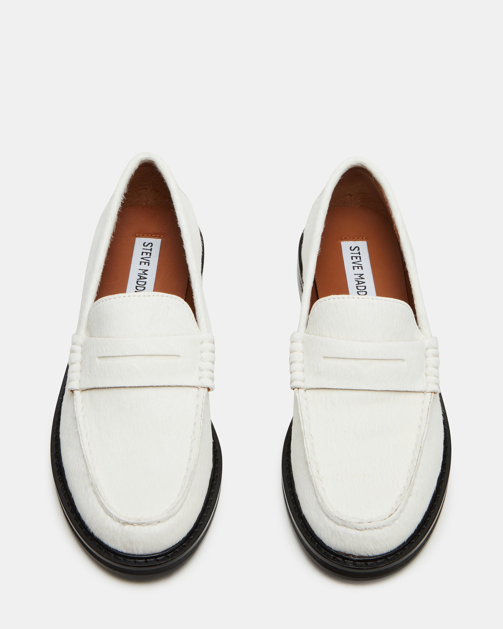 Side view of the MADISON white multi leather loafers on a wooden surface