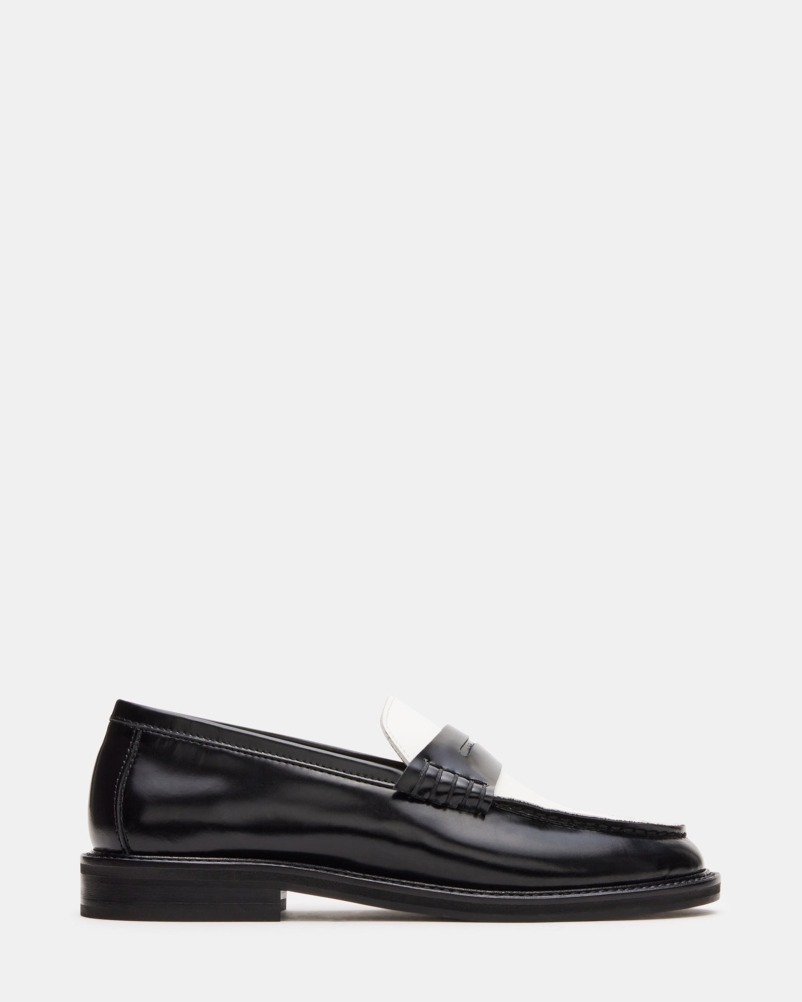 Madison black and white leather loafers front view, styled with tailored pants