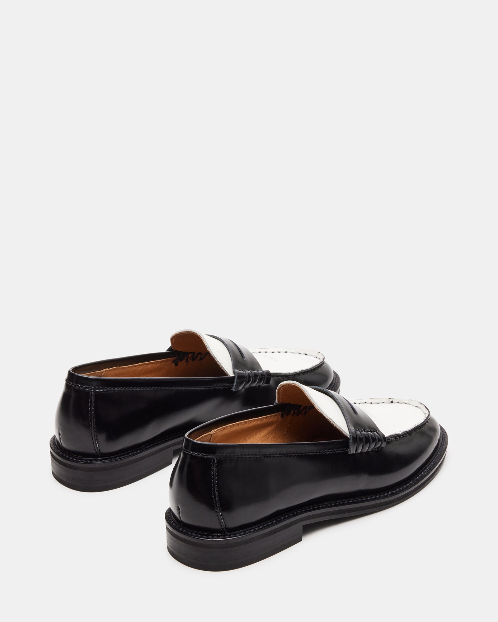 Side profile of womens patent leather loafers, showcasing sleek design