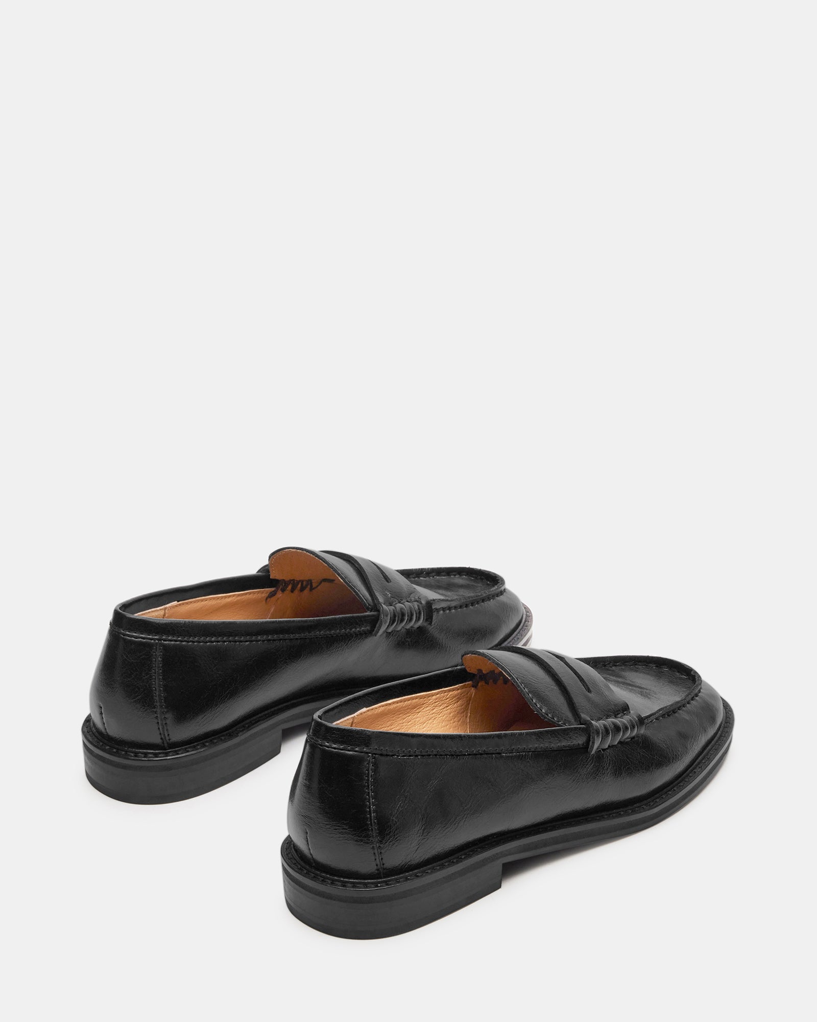 Stylish black Gucci-style loafers paired with slim-fit trousers