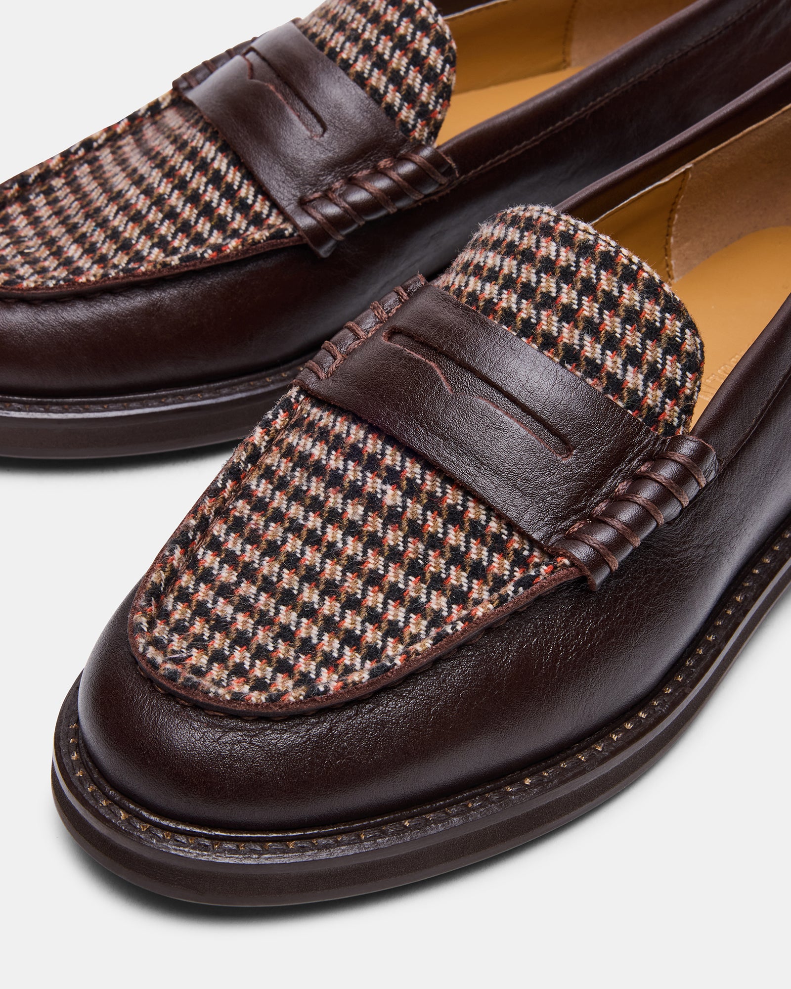 Detailed shot of the brown leather upper and synthetic sole of the loafers