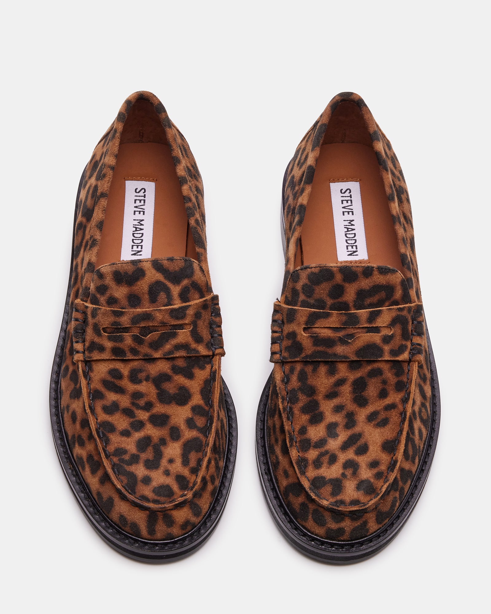 Close-up of mens loafers showing leopard print leather and stitching detail