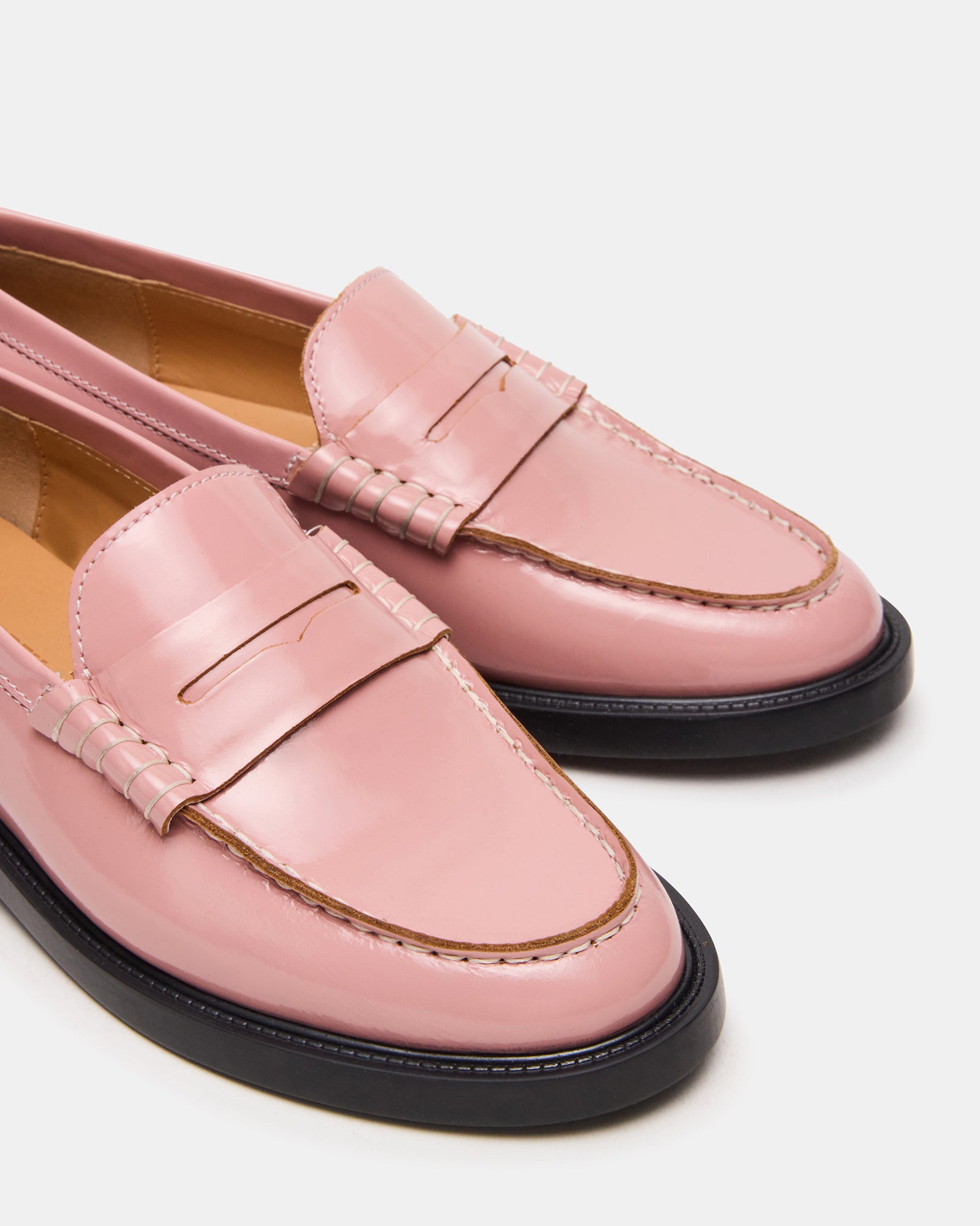 Side view of stylish loafers showing the 1-inch heel and synthetic sole