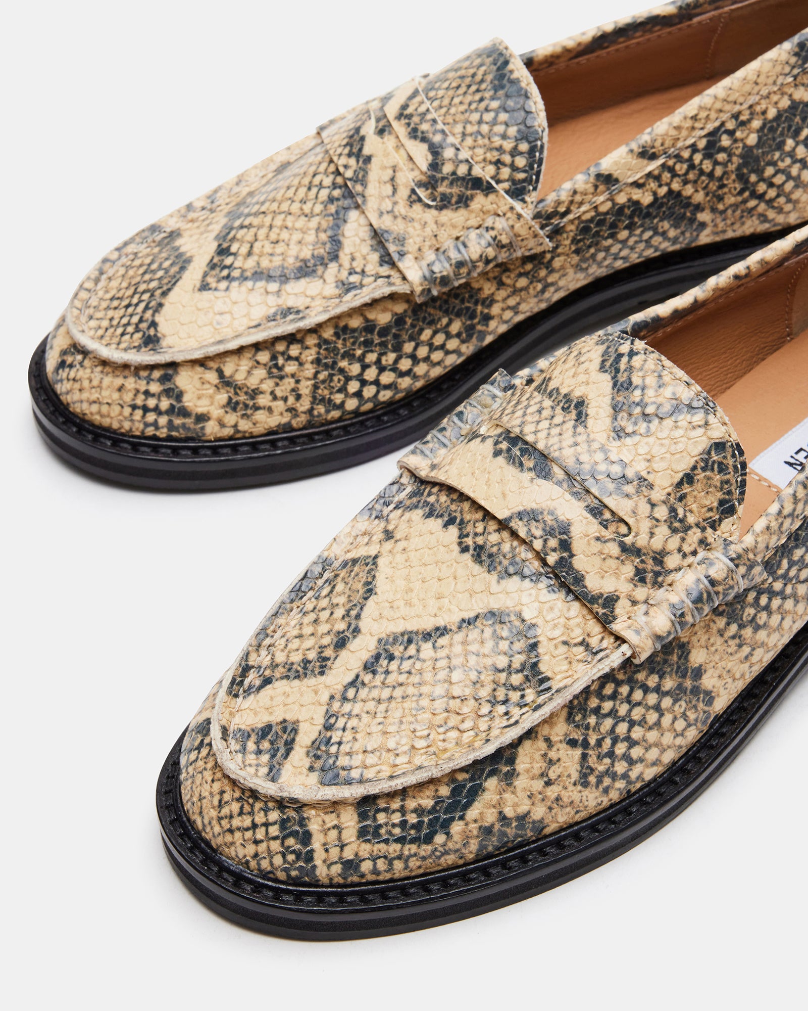 Close-up of the leather upper and synthetic sole of MADISON Snake loafer