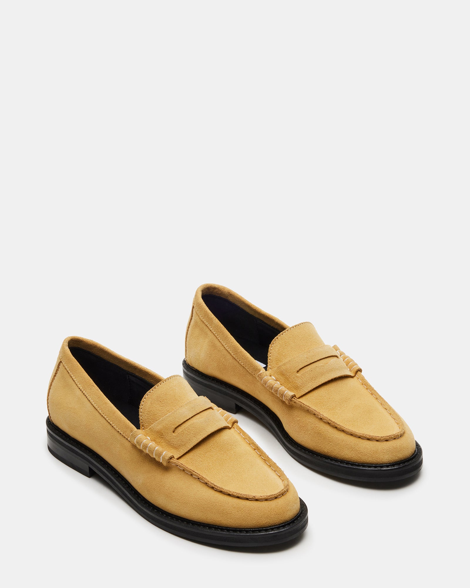 Side angle of mens shoes in yellow suede styled with tailored chinos