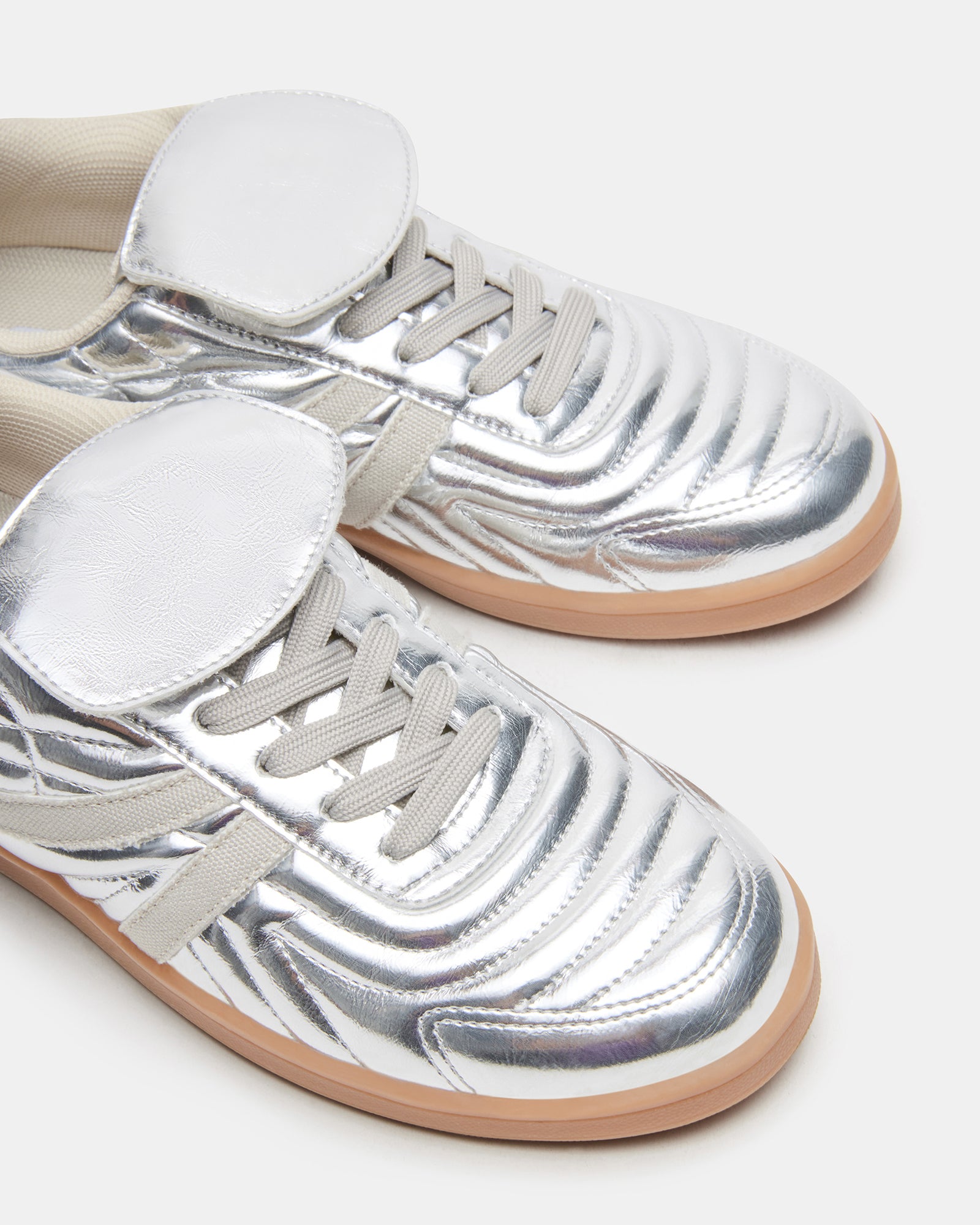 Madrid Silver sneakers side view on urban sidewalk