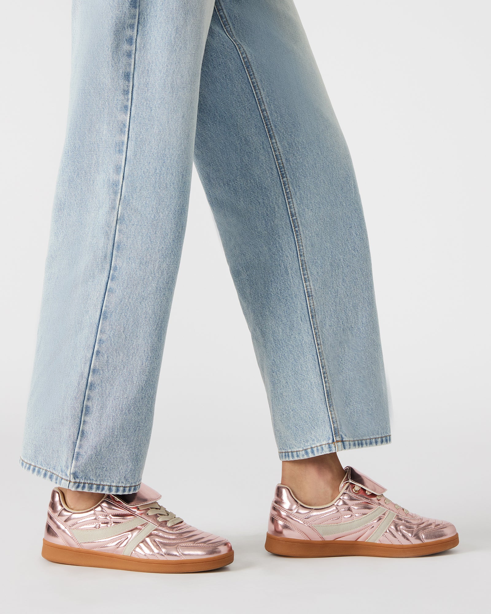 Close-up of the lace-up detail on these white fashion sneakers