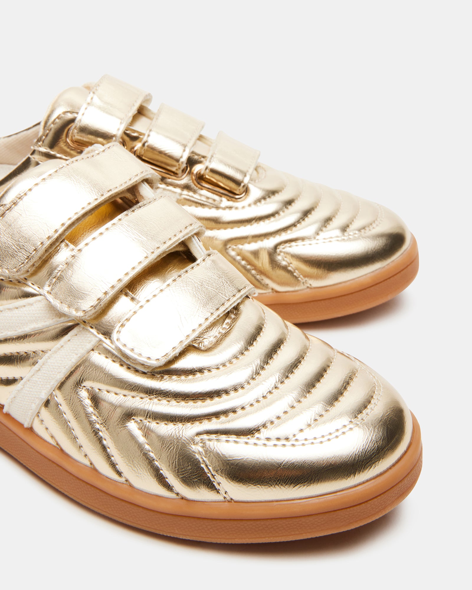 Lifestyle image of a person wearing MAGIK GOLD slip-on shoes while walking outdoors