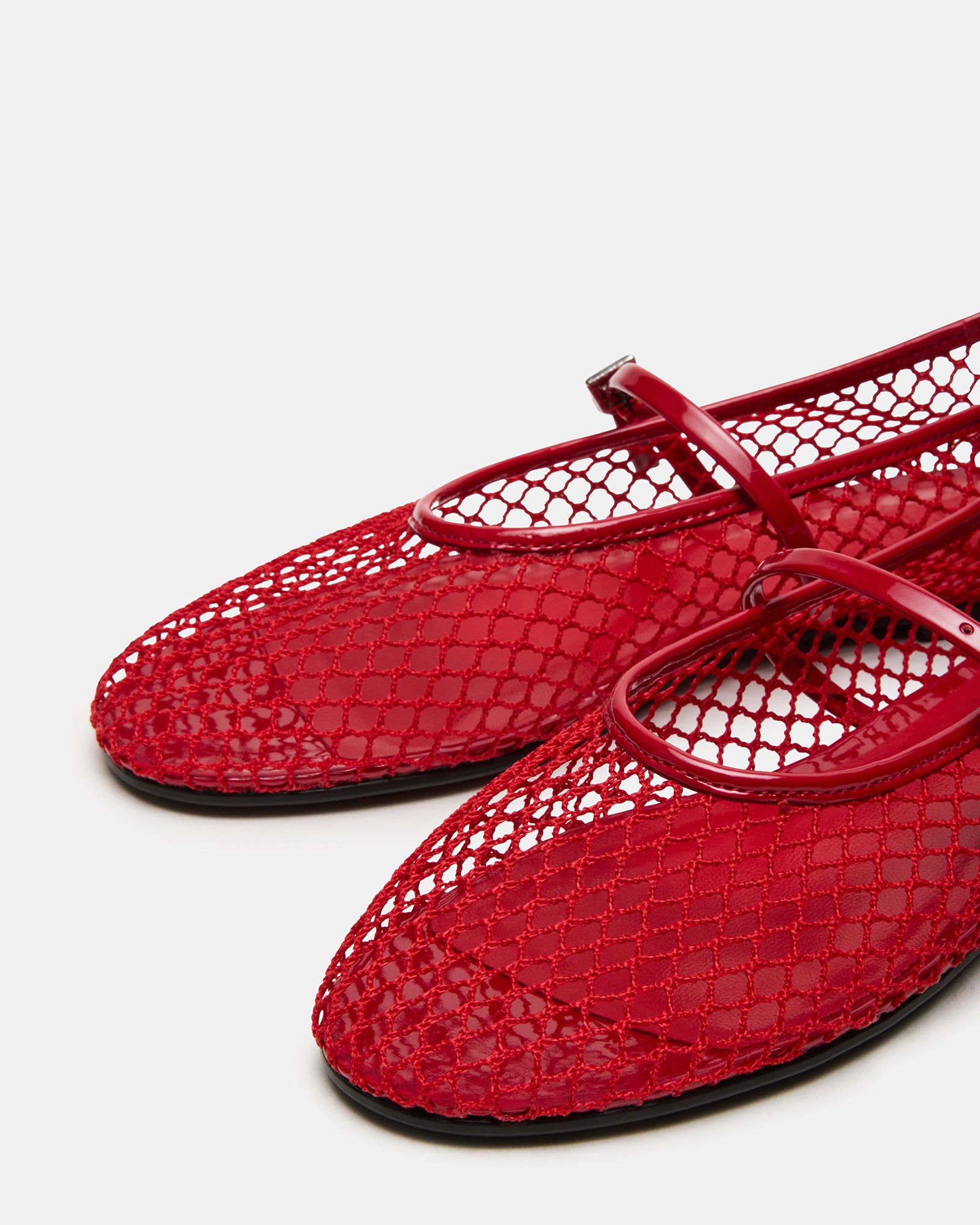 Close-up side view of red mesh Mary Jane flats showing ballet-style rounded toe