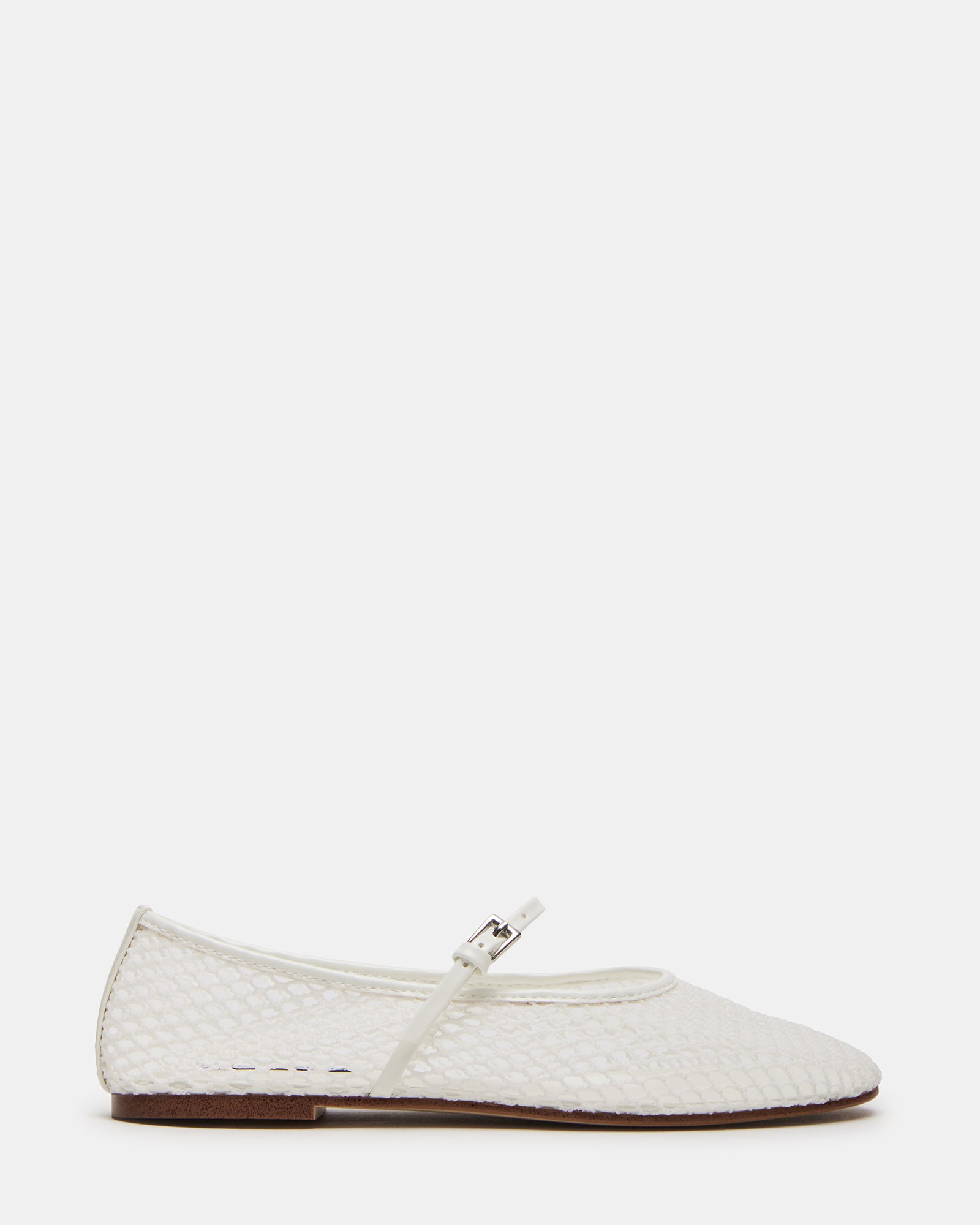 White Mary Jane flats on a wooden floor, showcasing the mesh upper.