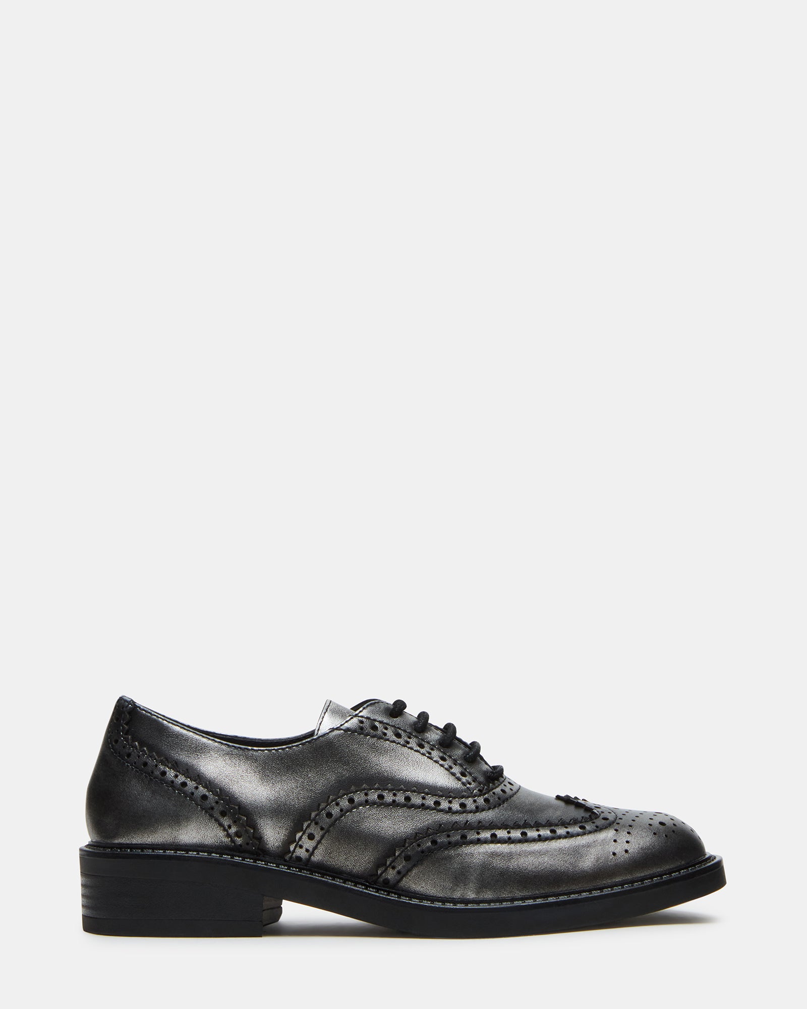 Side view of Malin silver leather loafers on a wooden floor.
