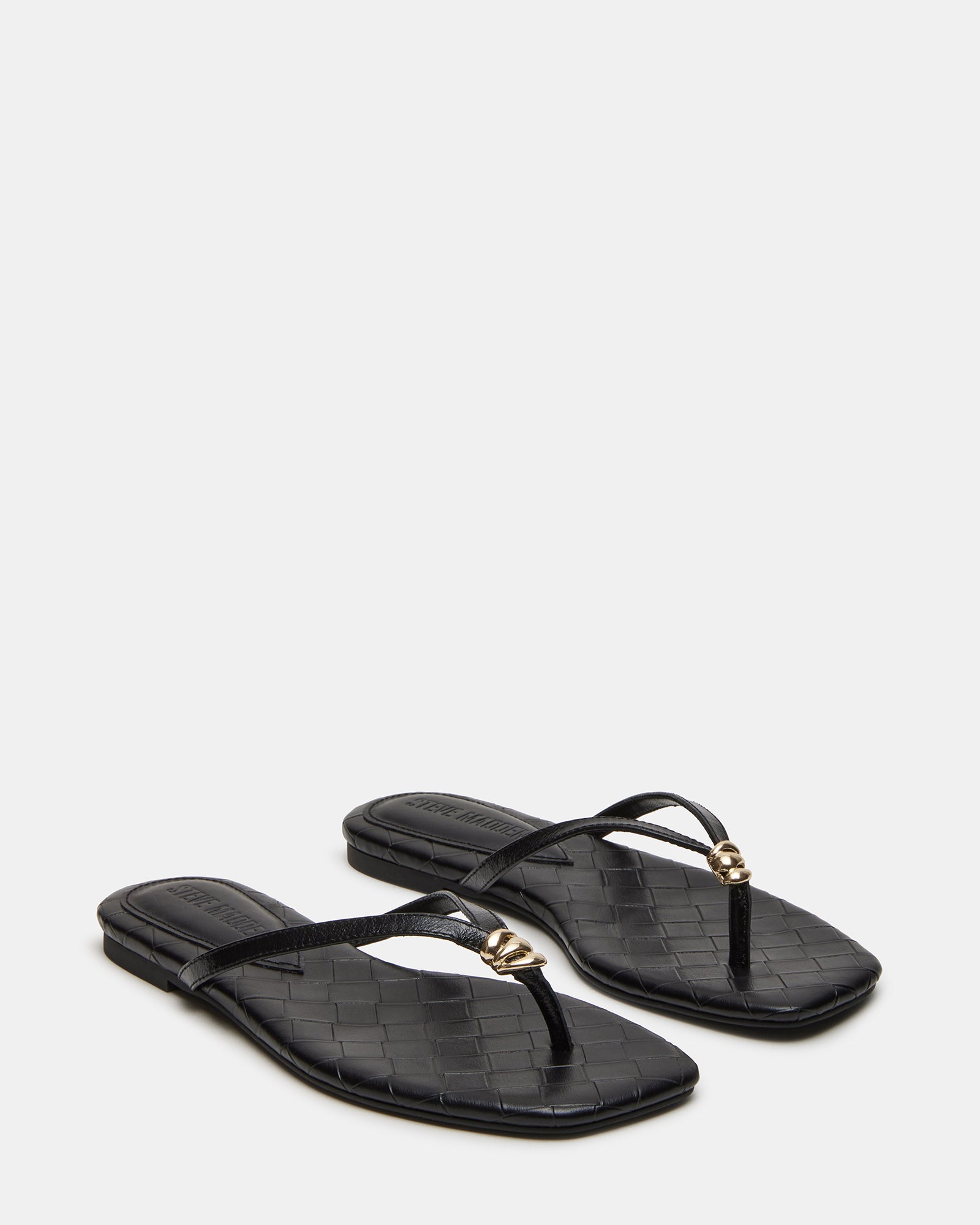 Close-up of the sleek square toe design on black leather sandals
