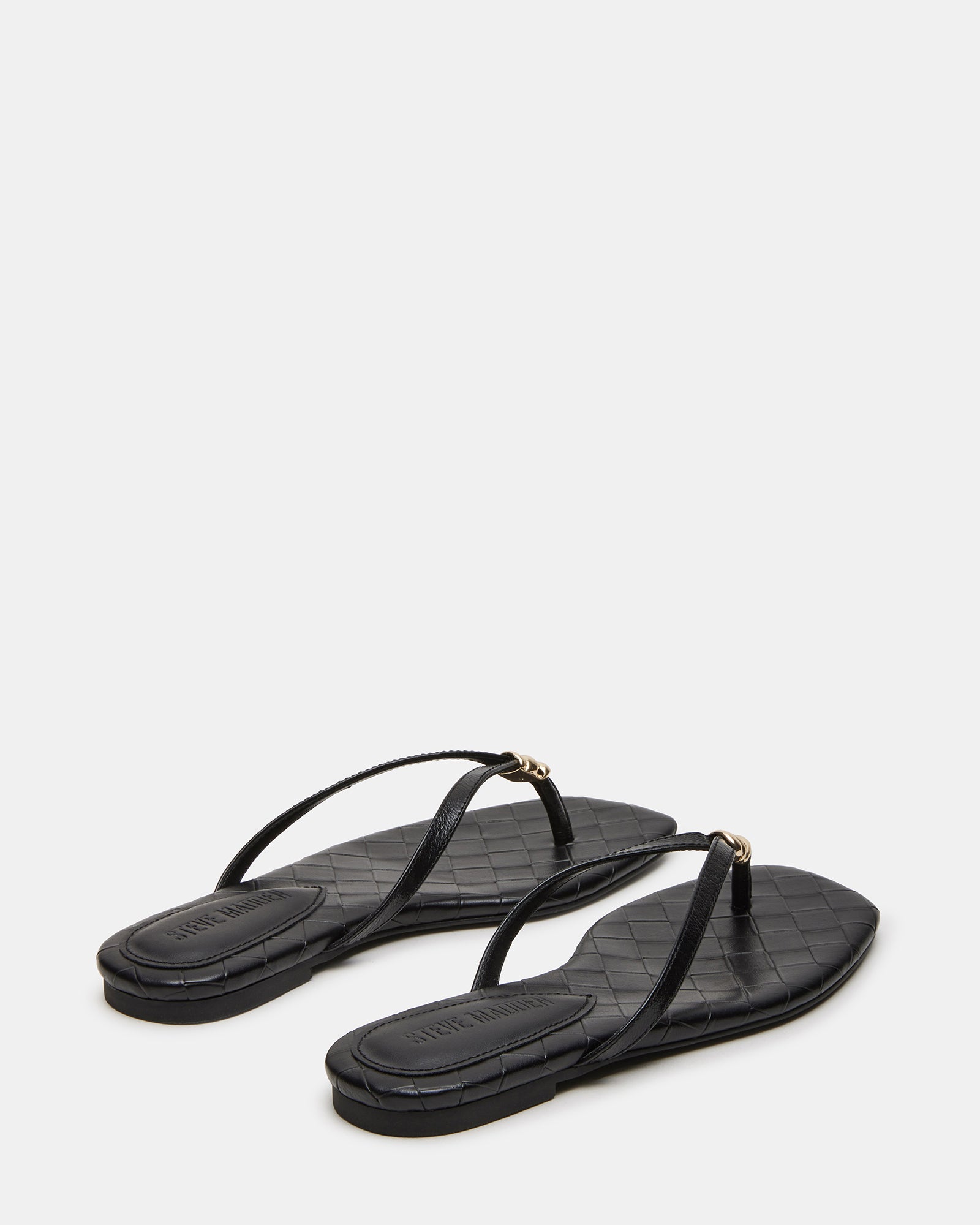 Close-up of the sleek square toe design on black leather sandals