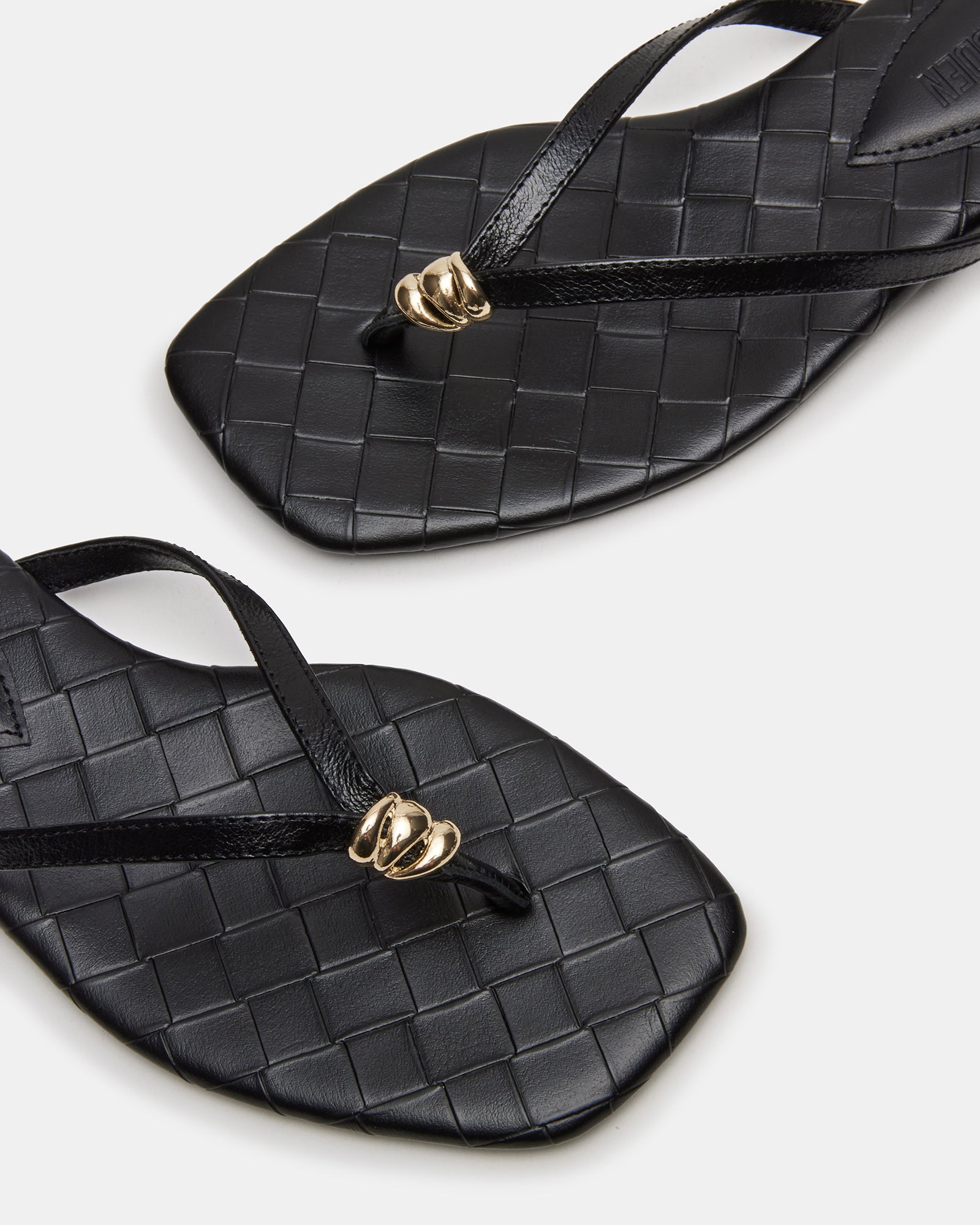 Women wearing black leather slide sandals in casual outdoor setting