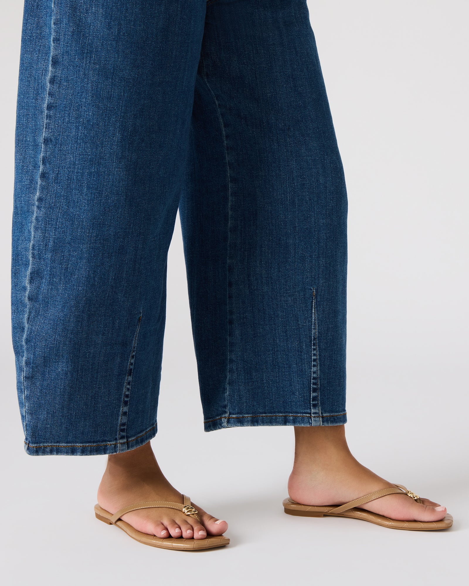 Side angle of stylish thong sandals with leather upper