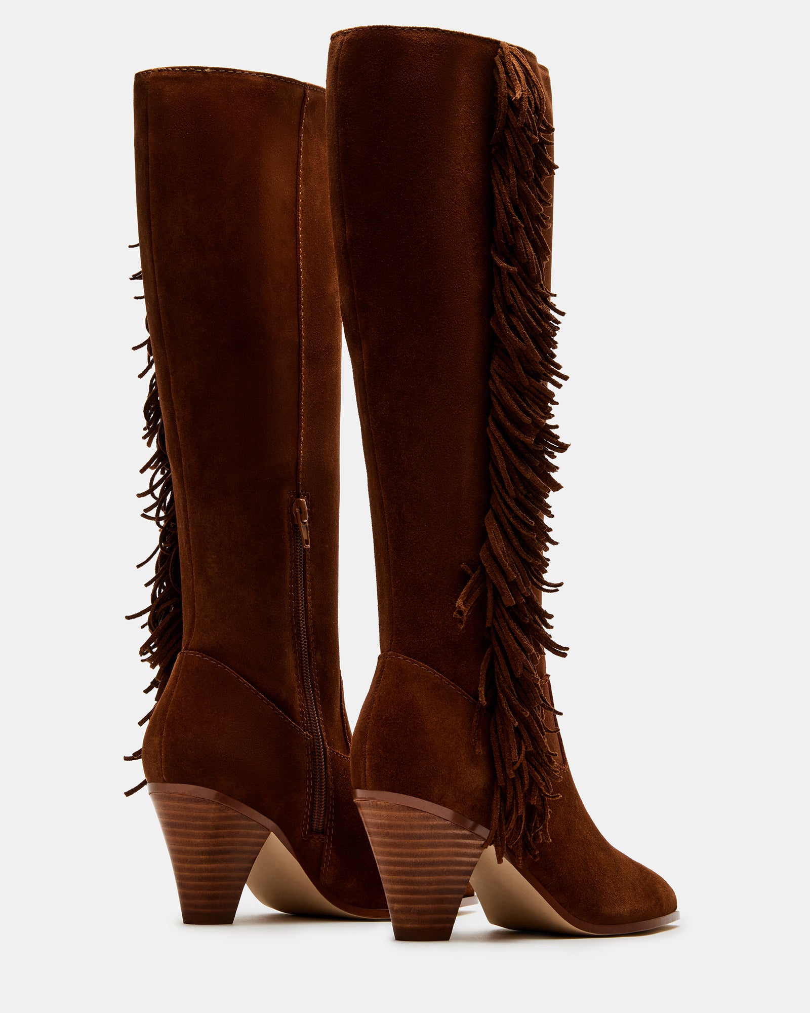 Woman wearing brown suede knee high boots at outdoor music festival