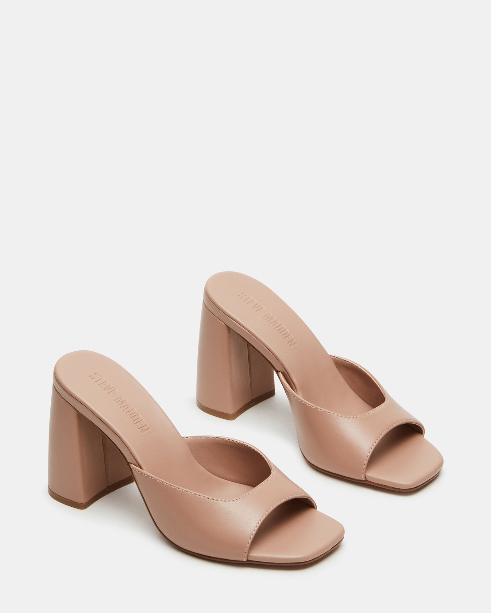 Close-up of leather mule heels highlighting the quality craftsmanship.