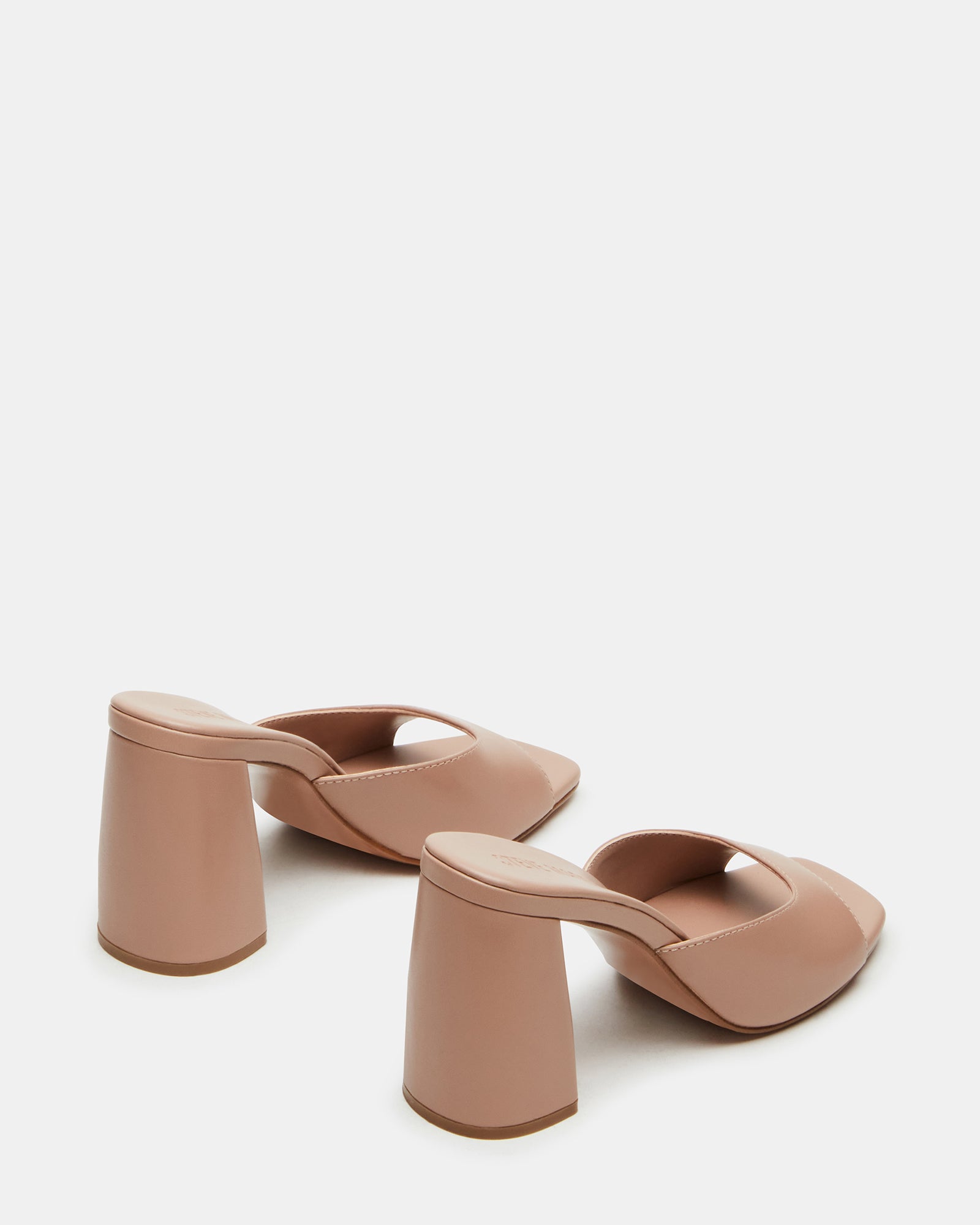 Close-up of leather mule heels highlighting the quality craftsmanship.