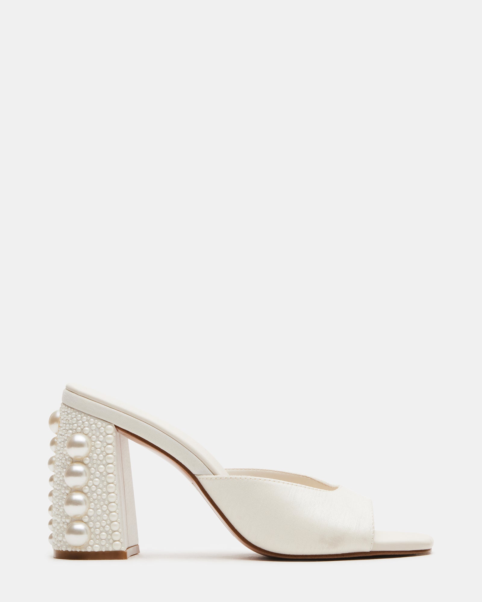 Side view of white mule heels showing square toe and block heel