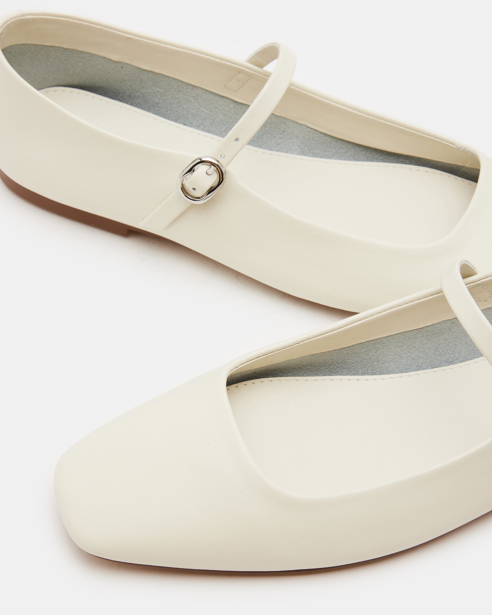 Maple Ivory ballet flats showing the Mary Jane design from the side.