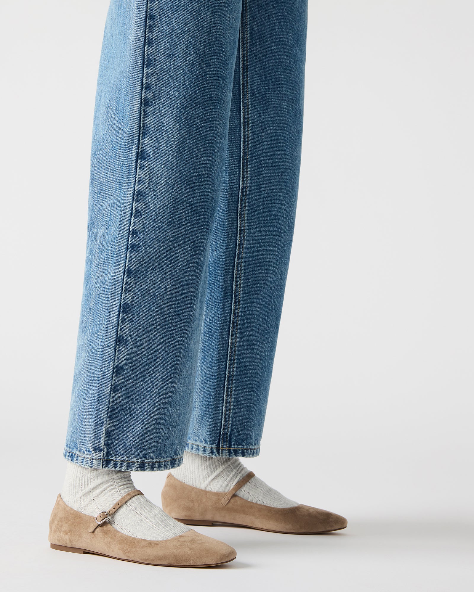 Side profile of red ballet flats styled with cropped jeans for casual Southern walks