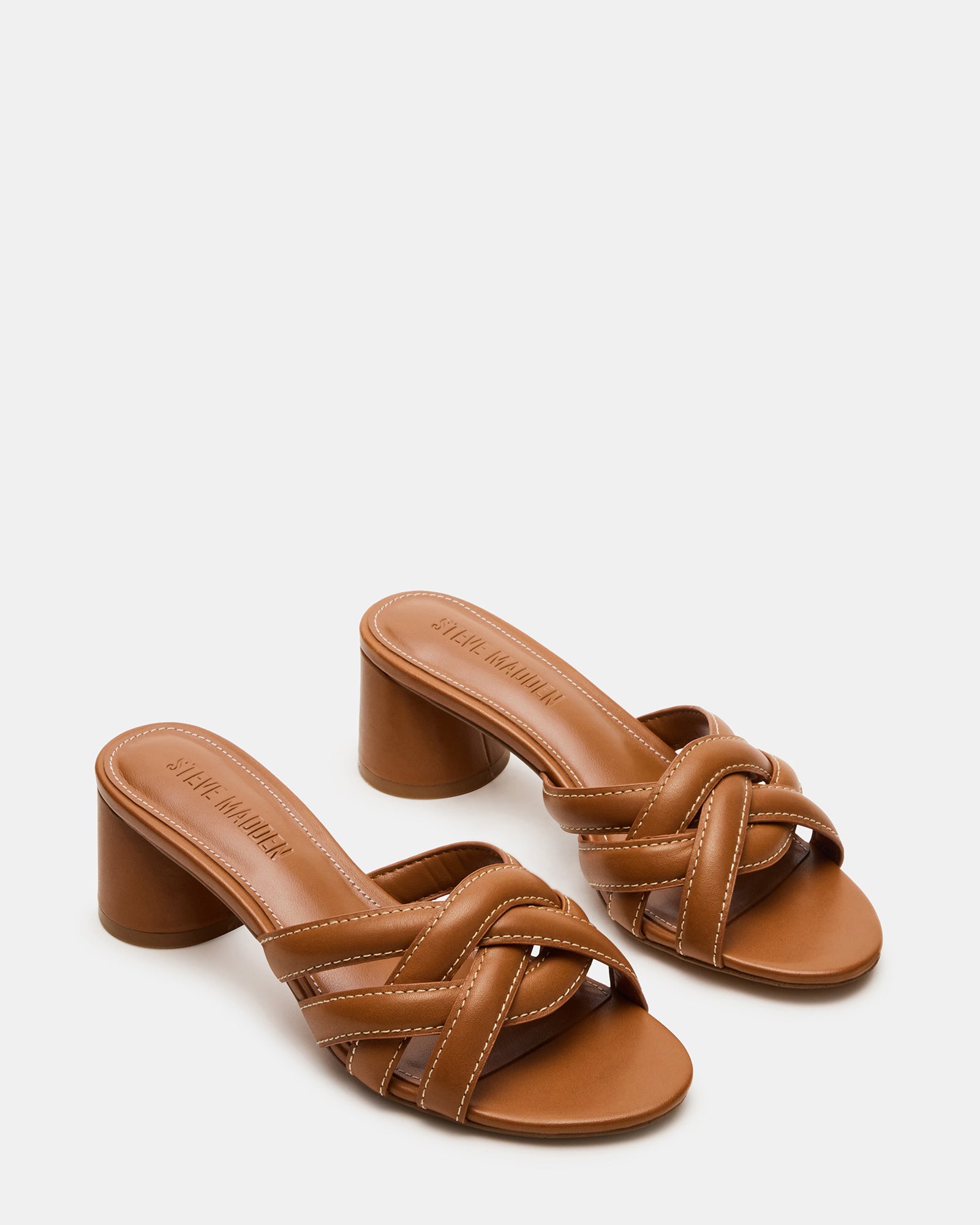Outdoor shot of block heel mule sandals in natural sunlight