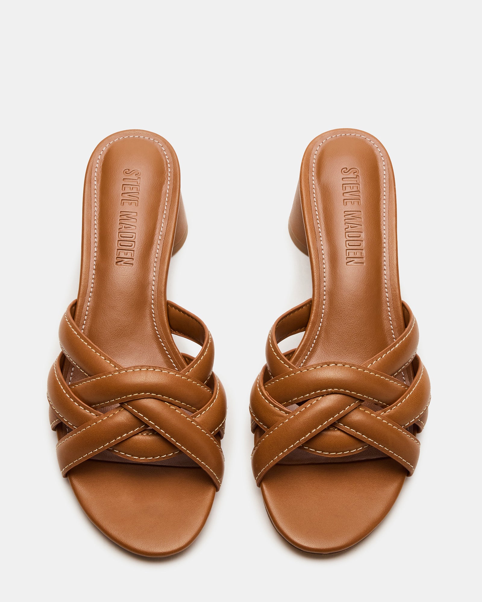 Side view of block heeled mules paired with cropped trousers
