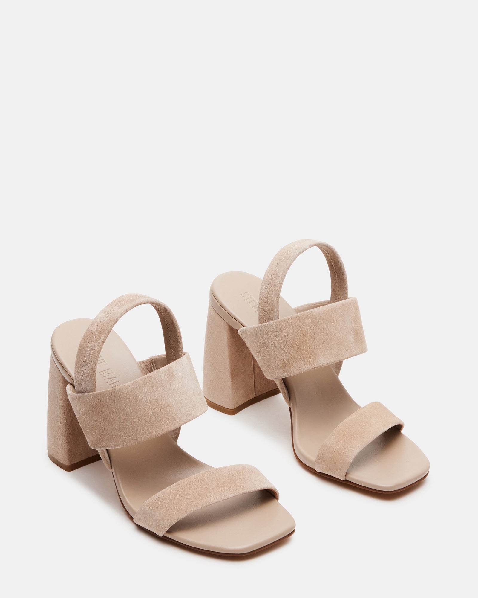 Side profile of sueded heels worn with a linen dress for a relaxed beach dinner