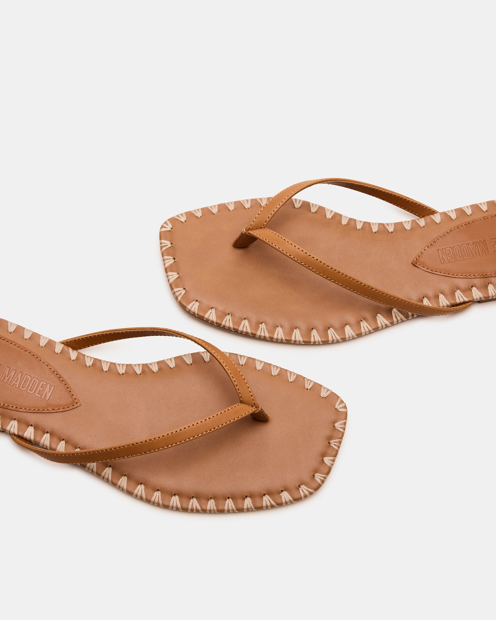 Side view of MARELLA cognac leather sandals on a wooden surface.